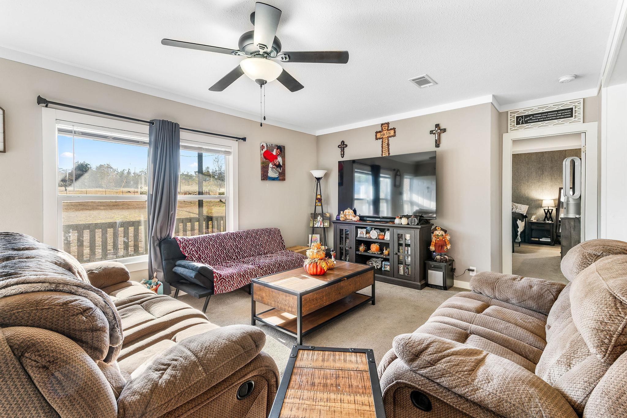Image 2: Living room with a ceiling fan, carpet floors, and ornamental molding, Living Room