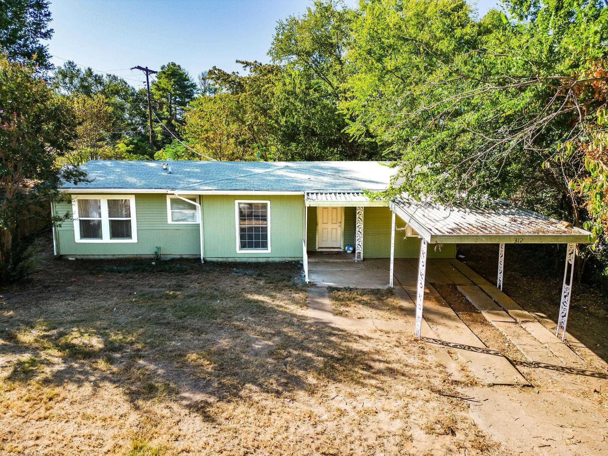 Image 0: Ranch-style house featuring an attached carport and a porch, Front Of Structure
