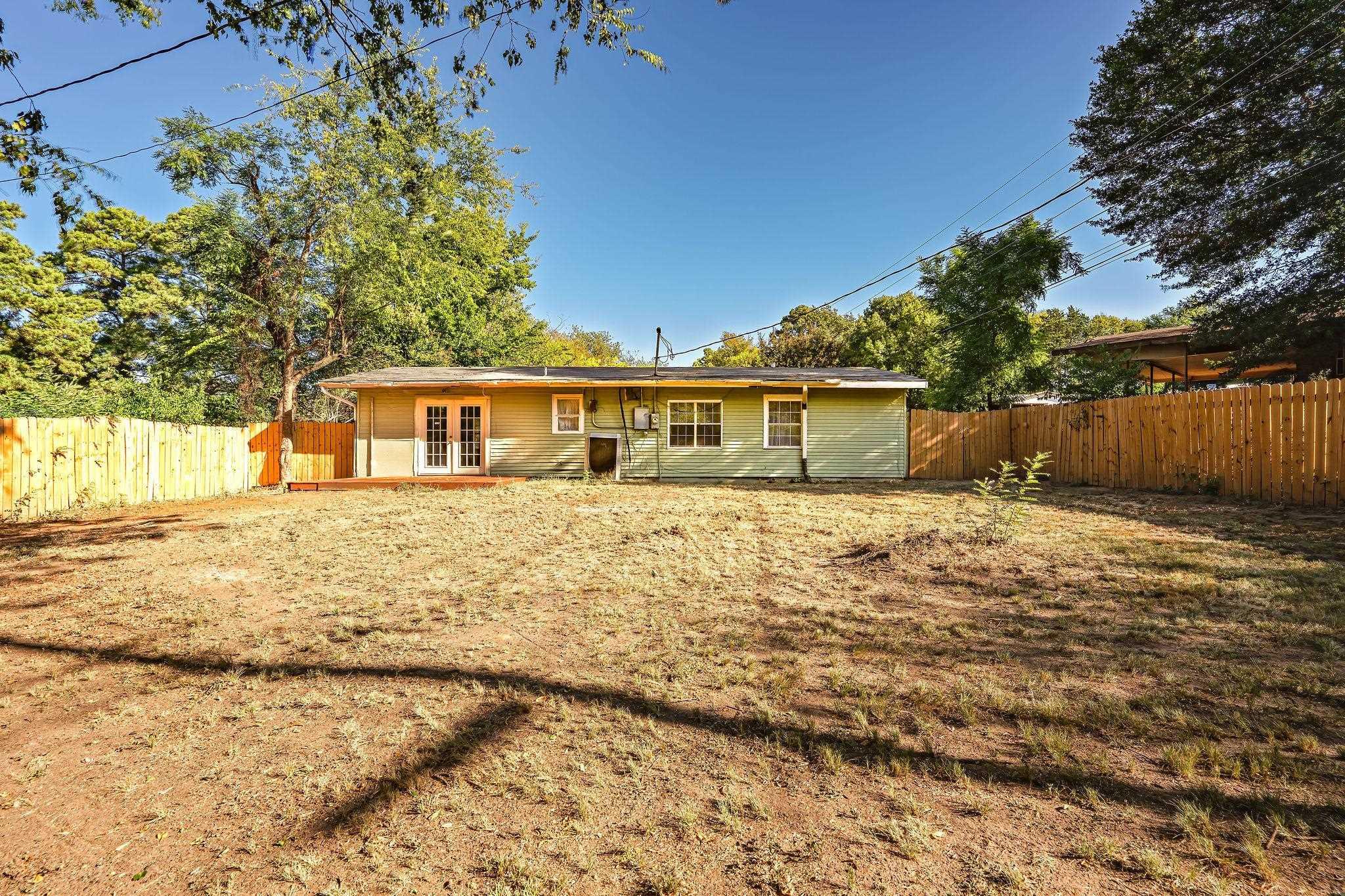 Image 3: Rear view of house with french doors, a fenced backyard, and a patio, Back Of Structure