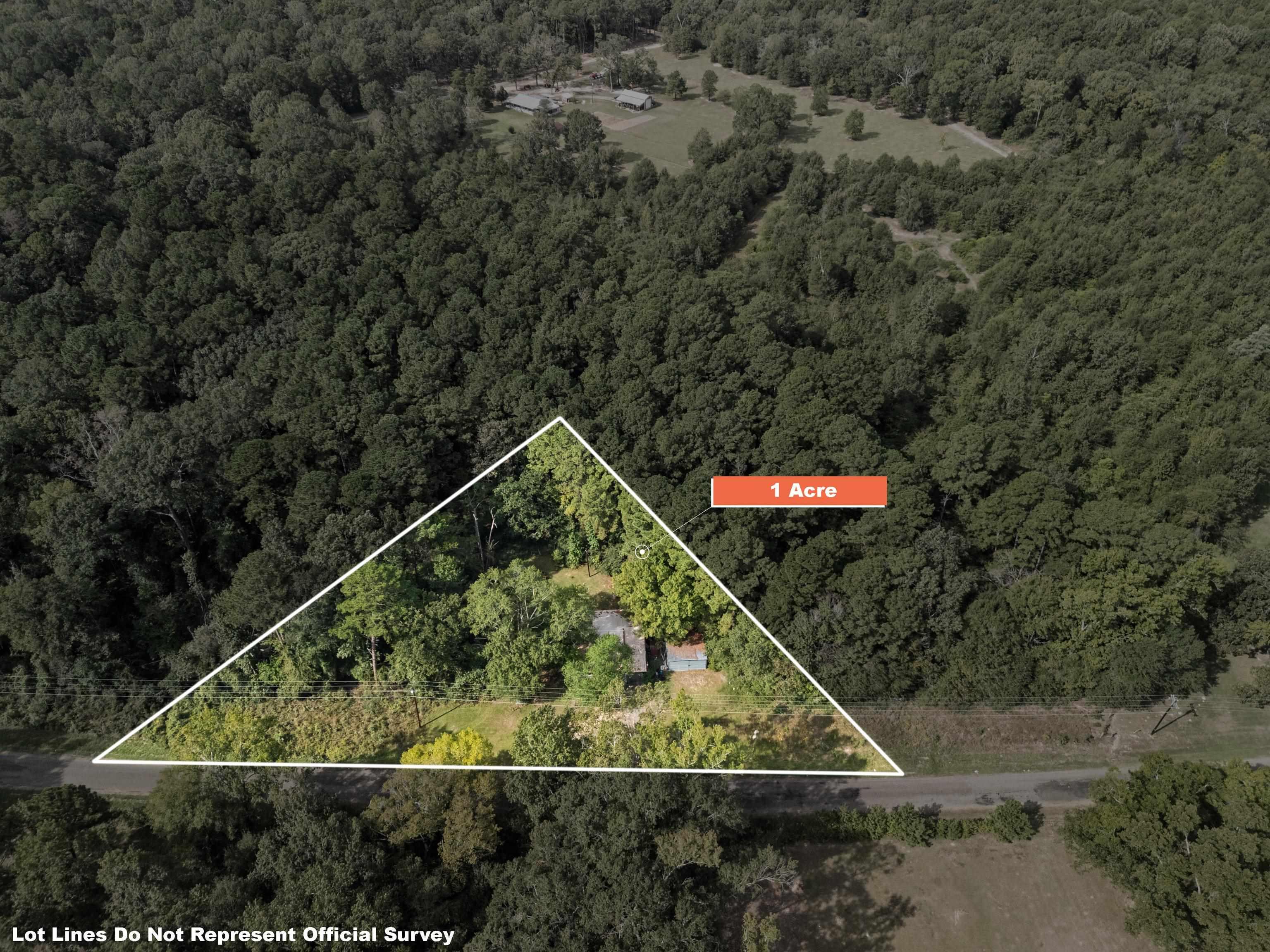 Image 2: Aerial overview of property's location featuring a forest and property parcel outlined, Aerial View