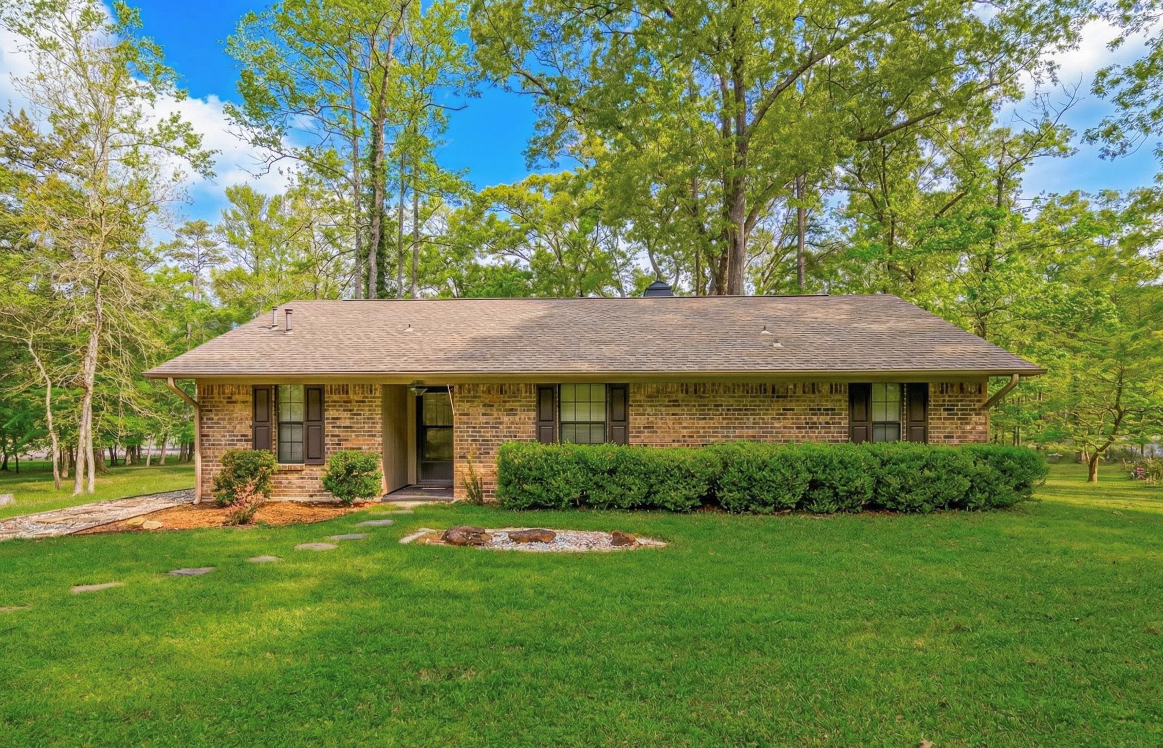 Image 0: View of front of home featuring a front yard, brick siding, and roof with shingles, Front Of Structure