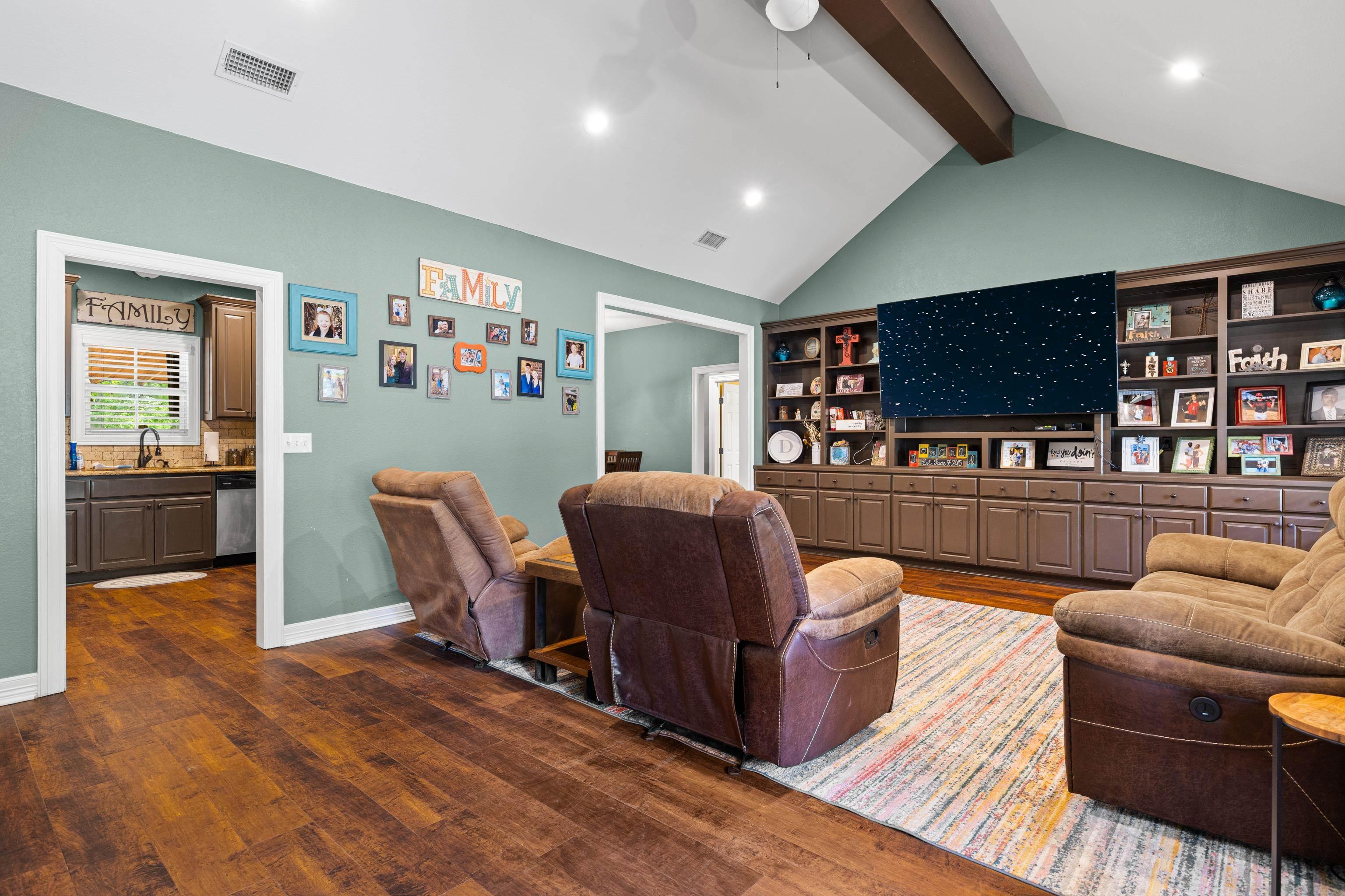 Image 3: Living room featuring dark wood-style flooring, beamed ceiling, ceiling fan, and recessed lighting, Living Room