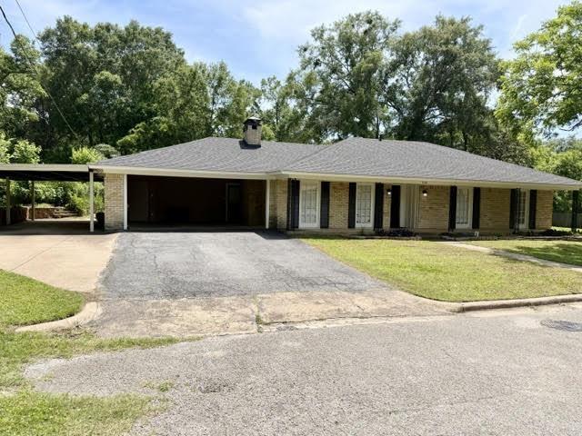 Image 1: Ranch-style residence featuring a light brick facade and a dark shingle roof, Front Of Structure