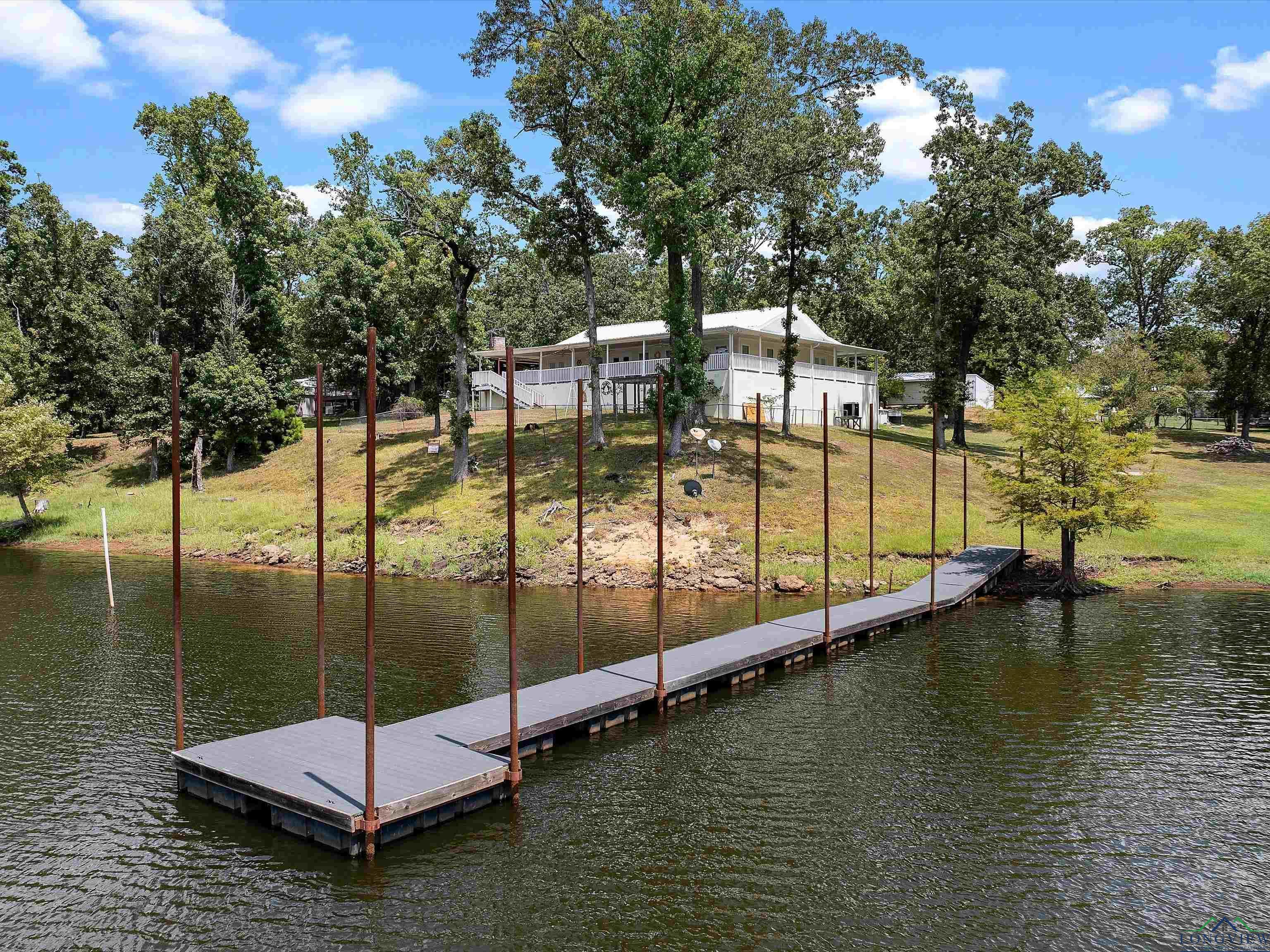 Image 1: Dock area featuring a water view and a yard, Dock