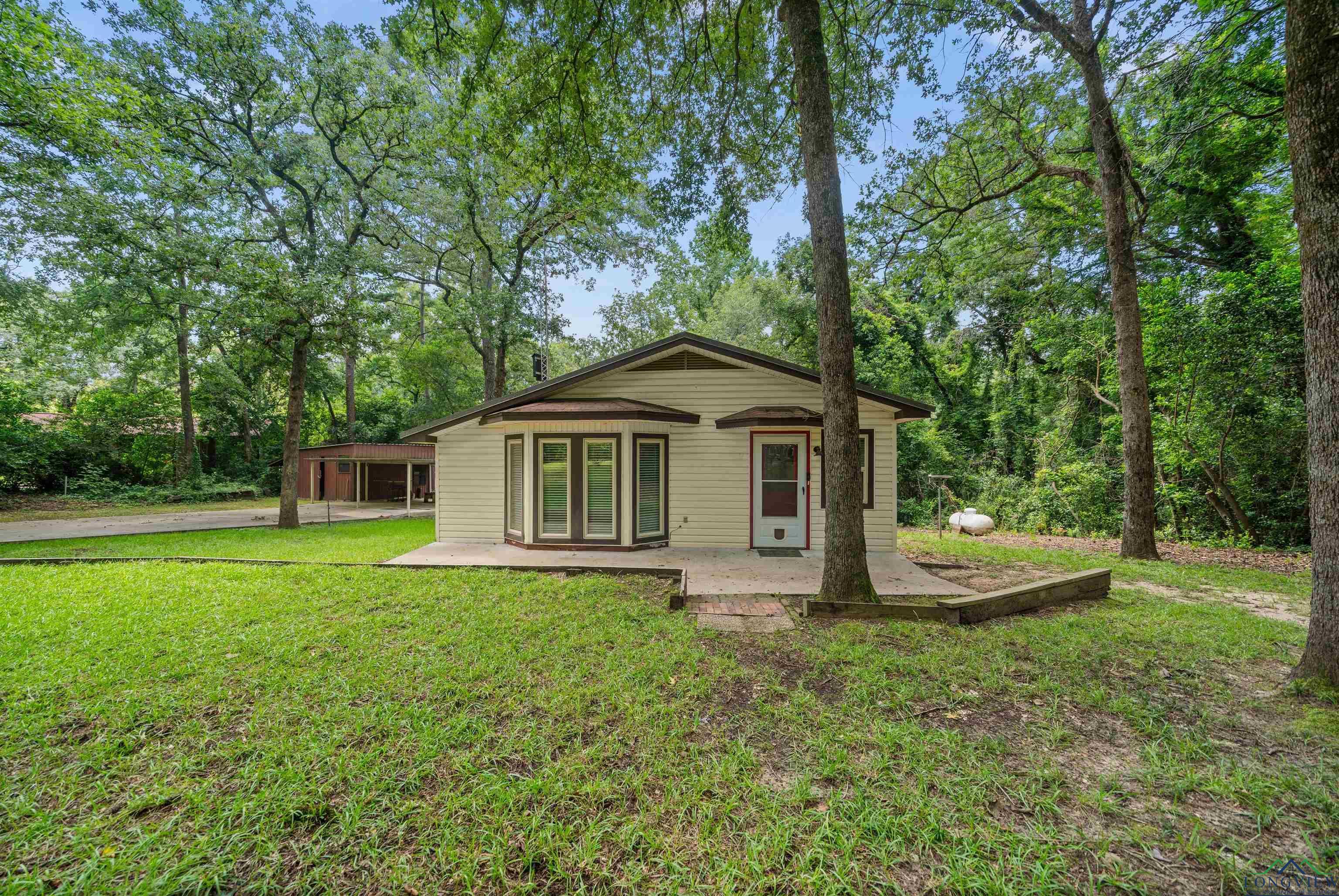 Image 1: View of front of home featuring a front lawn, french doors, and driveway, Front Of Structure