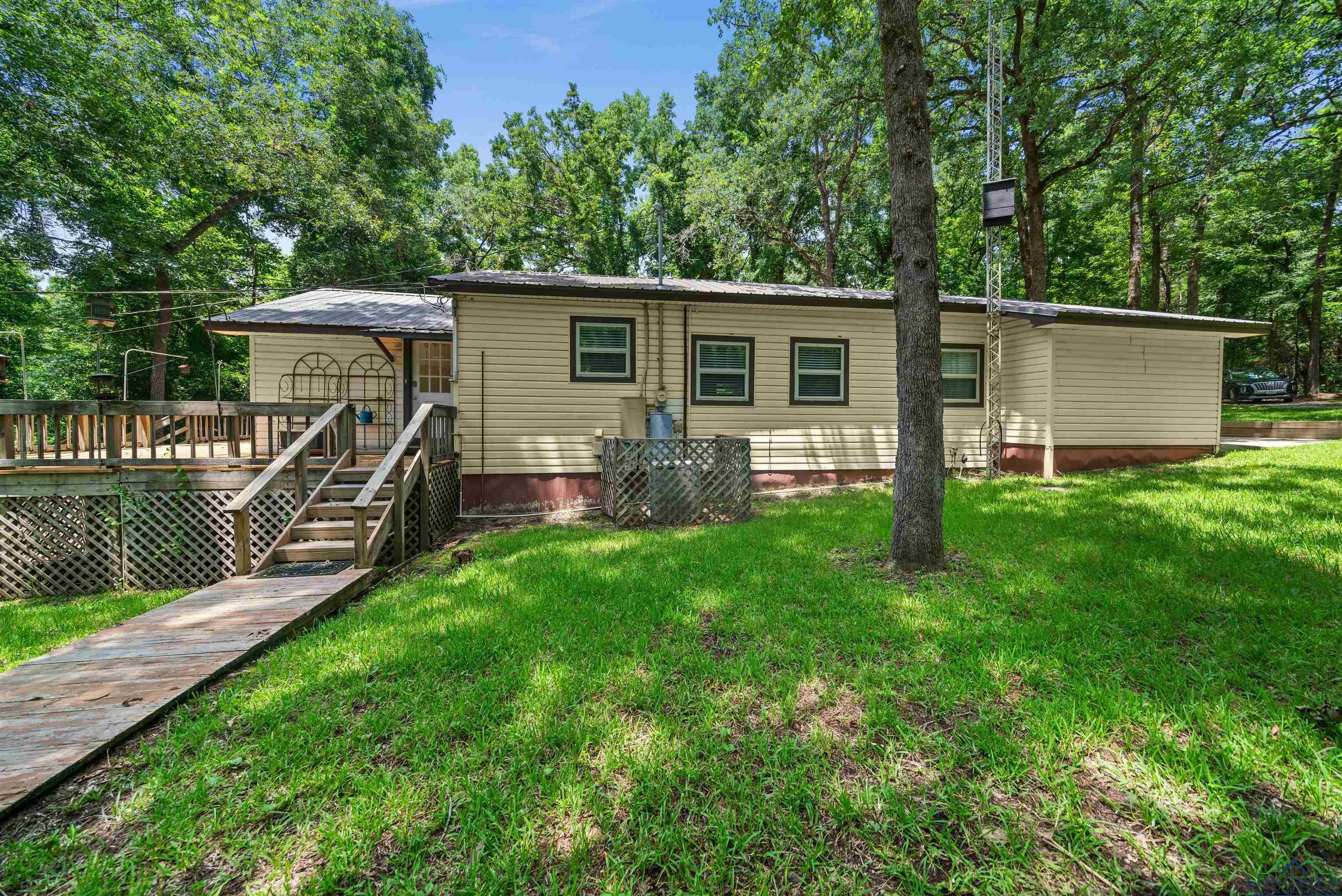Image 2: Back of house featuring a wooden deck and a yard, Back Of Structure