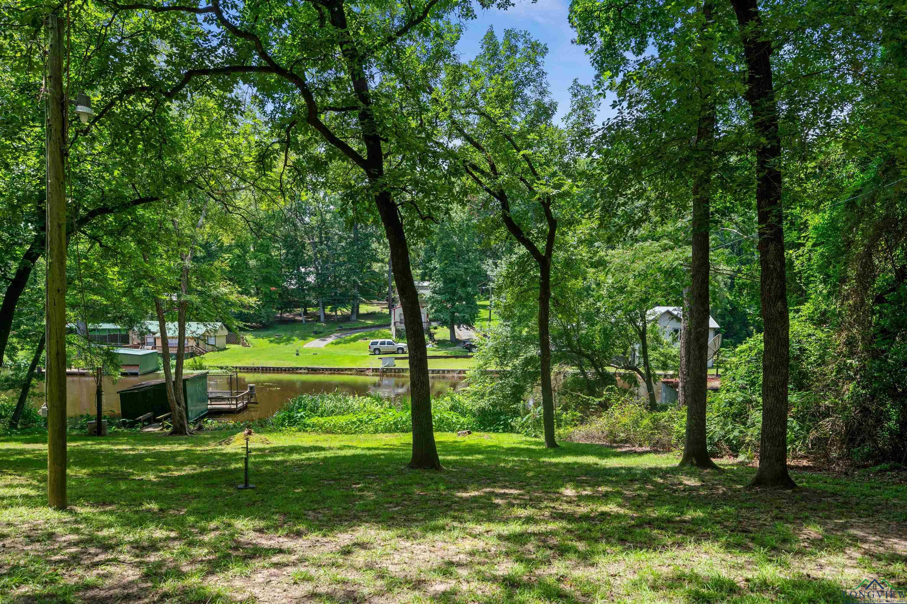 Image 3: View of grassy yard featuring a water view, Yard