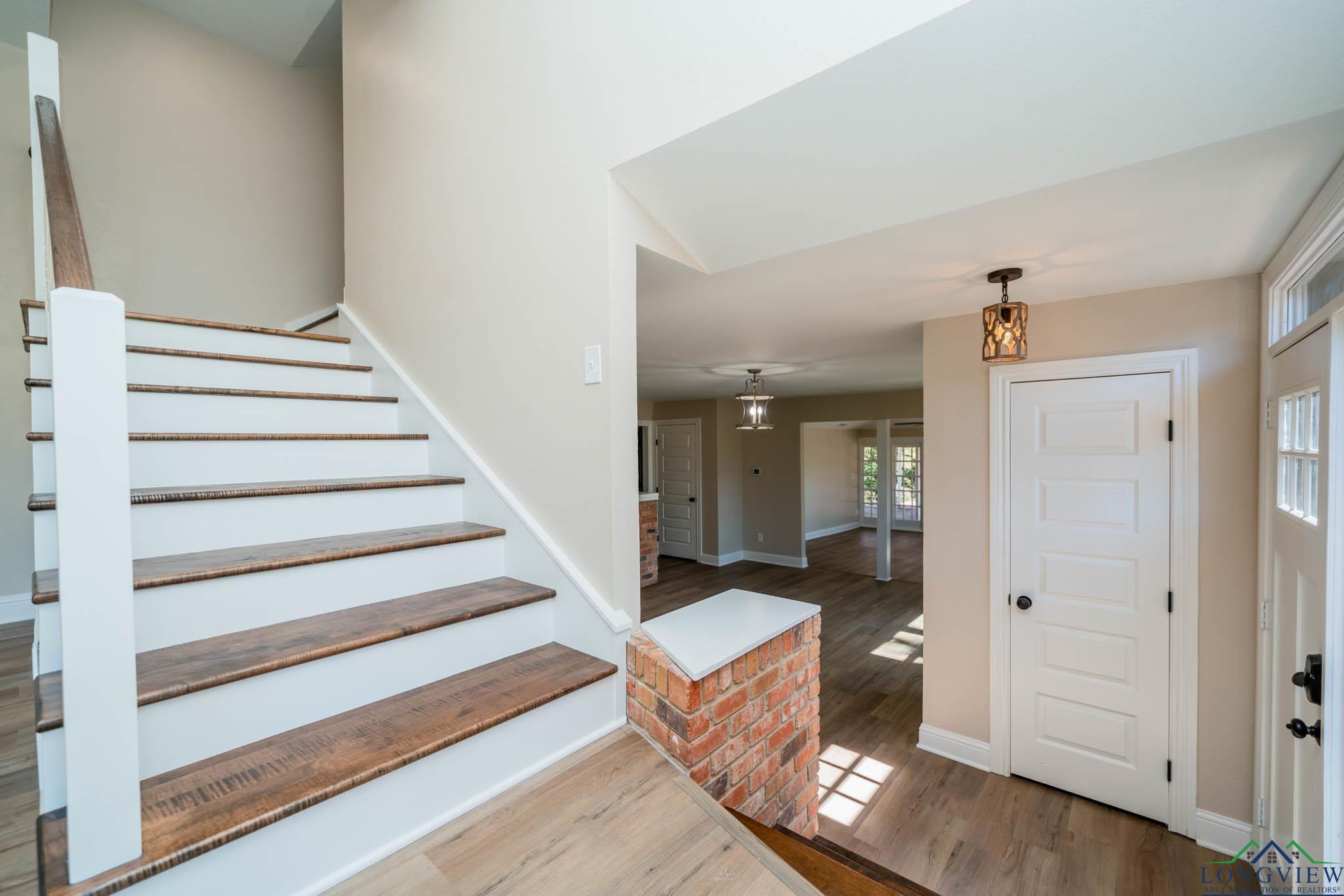 Image 3: Entryway with wood finished floors and stairs, Entrance Foyer