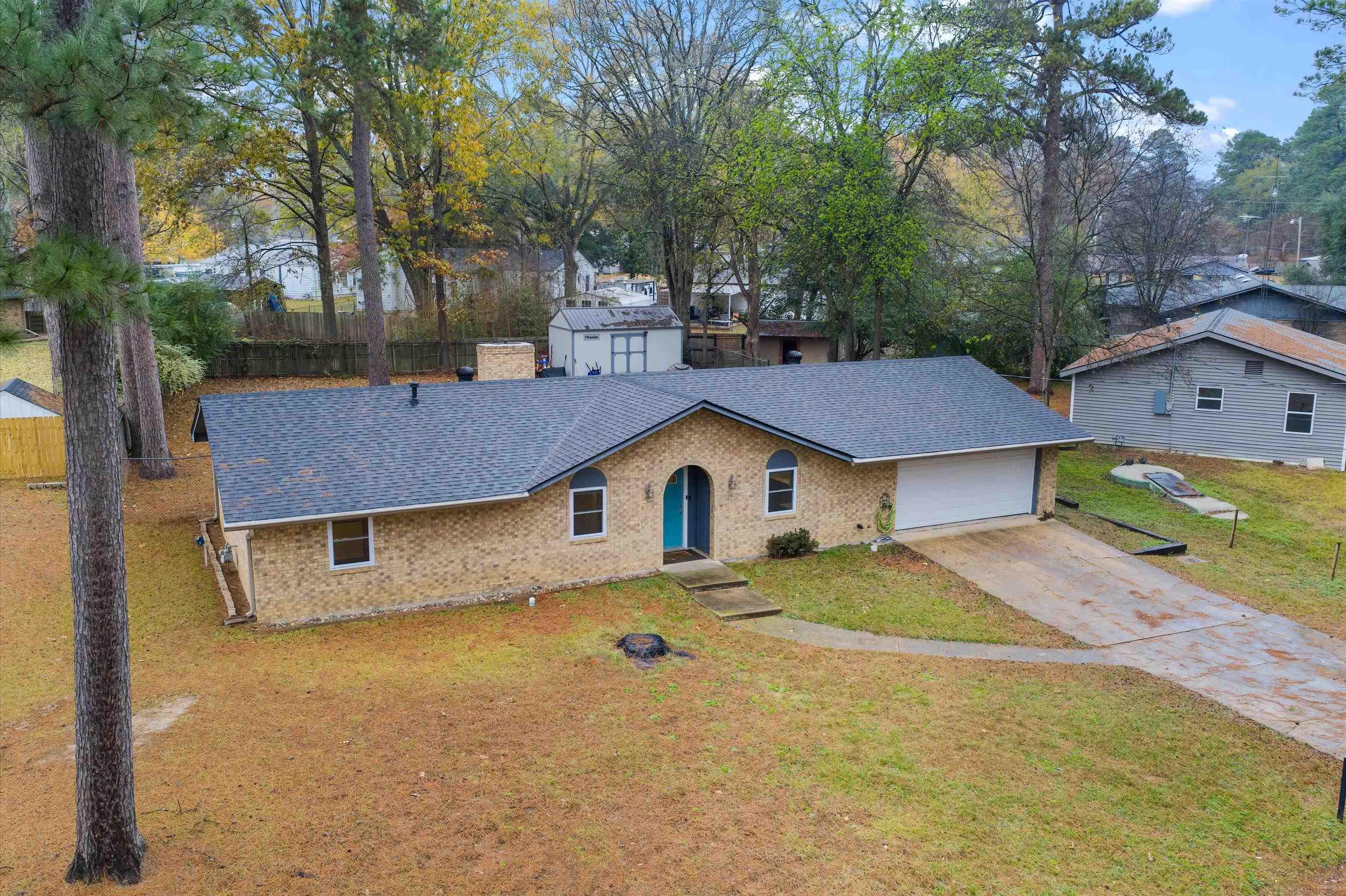 Image 2: Ranch-style house with driveway, roof with shingles, and brick siding, Front Of Structure