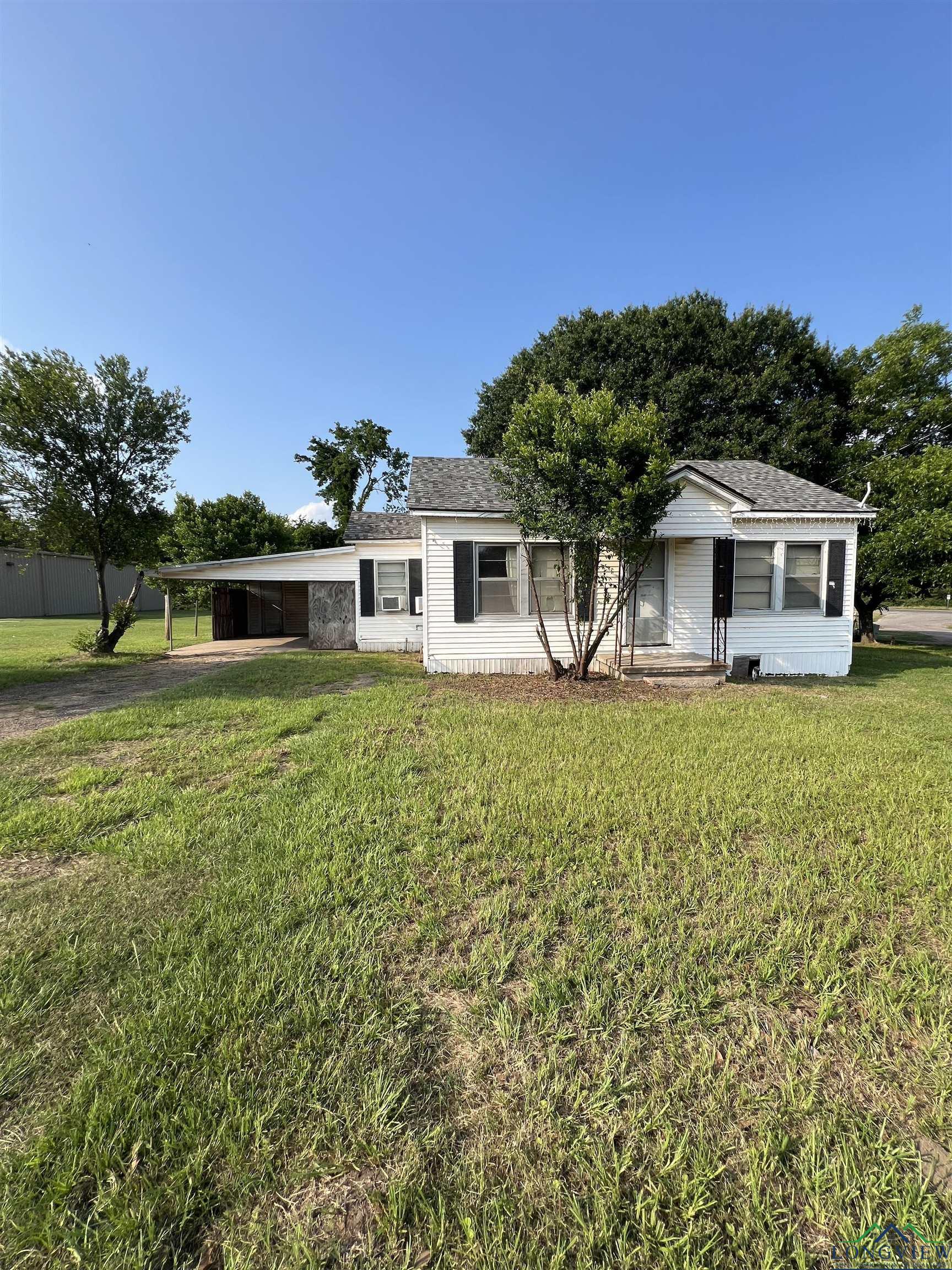 Image 3: View of front facade featuring driveway, a carport, and a front yard, Front Of Structure