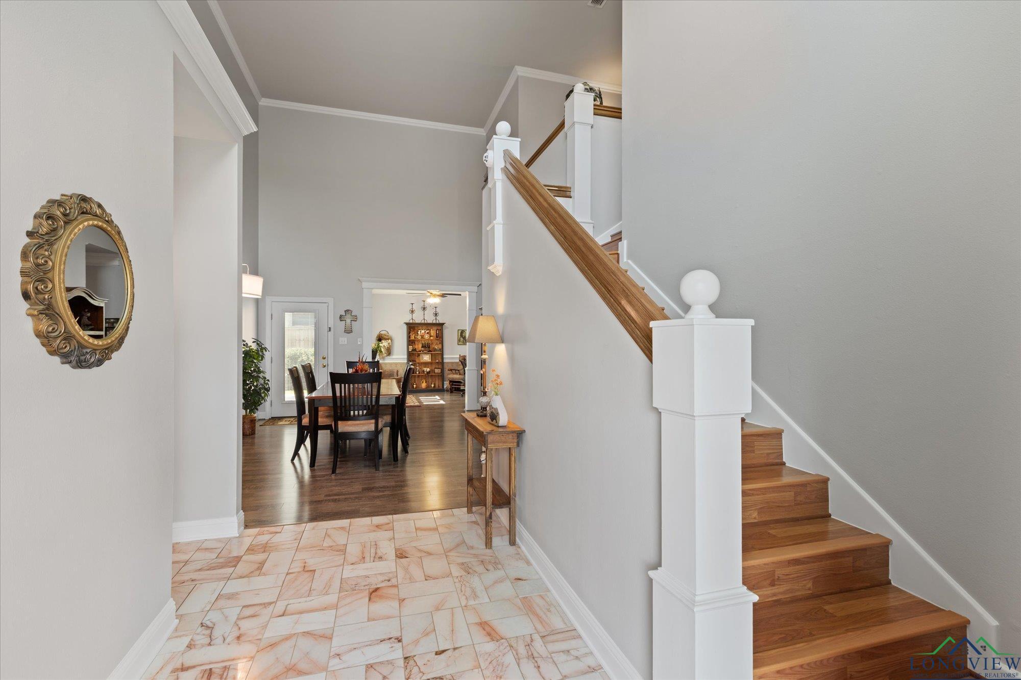Image 2: Foyer entrance featuring stairway, a high ceiling, crown molding, and light marble finish floors, Entrance Foyer