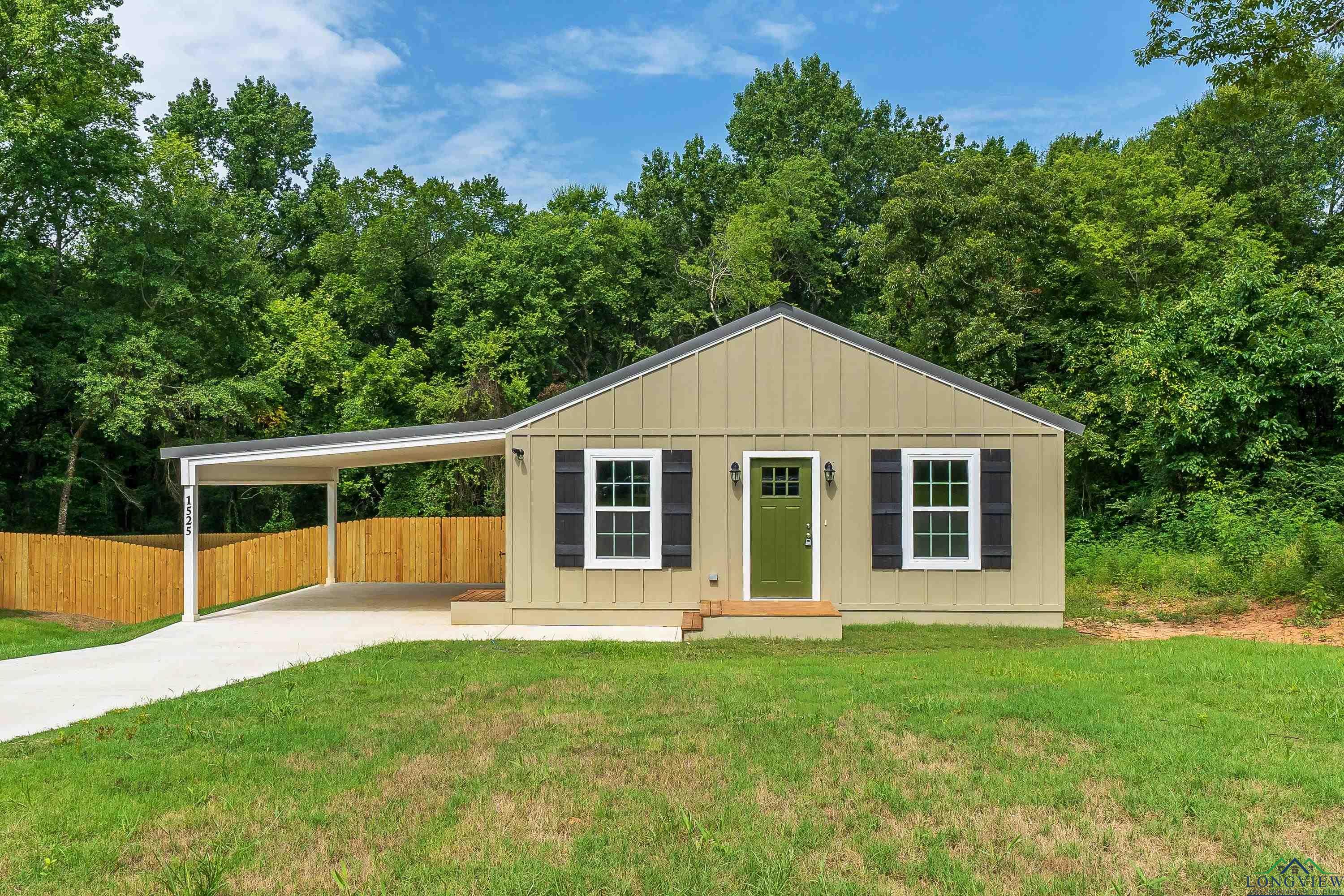 Image 0: Bungalow with board and batten siding and driveway, Front Of Structure