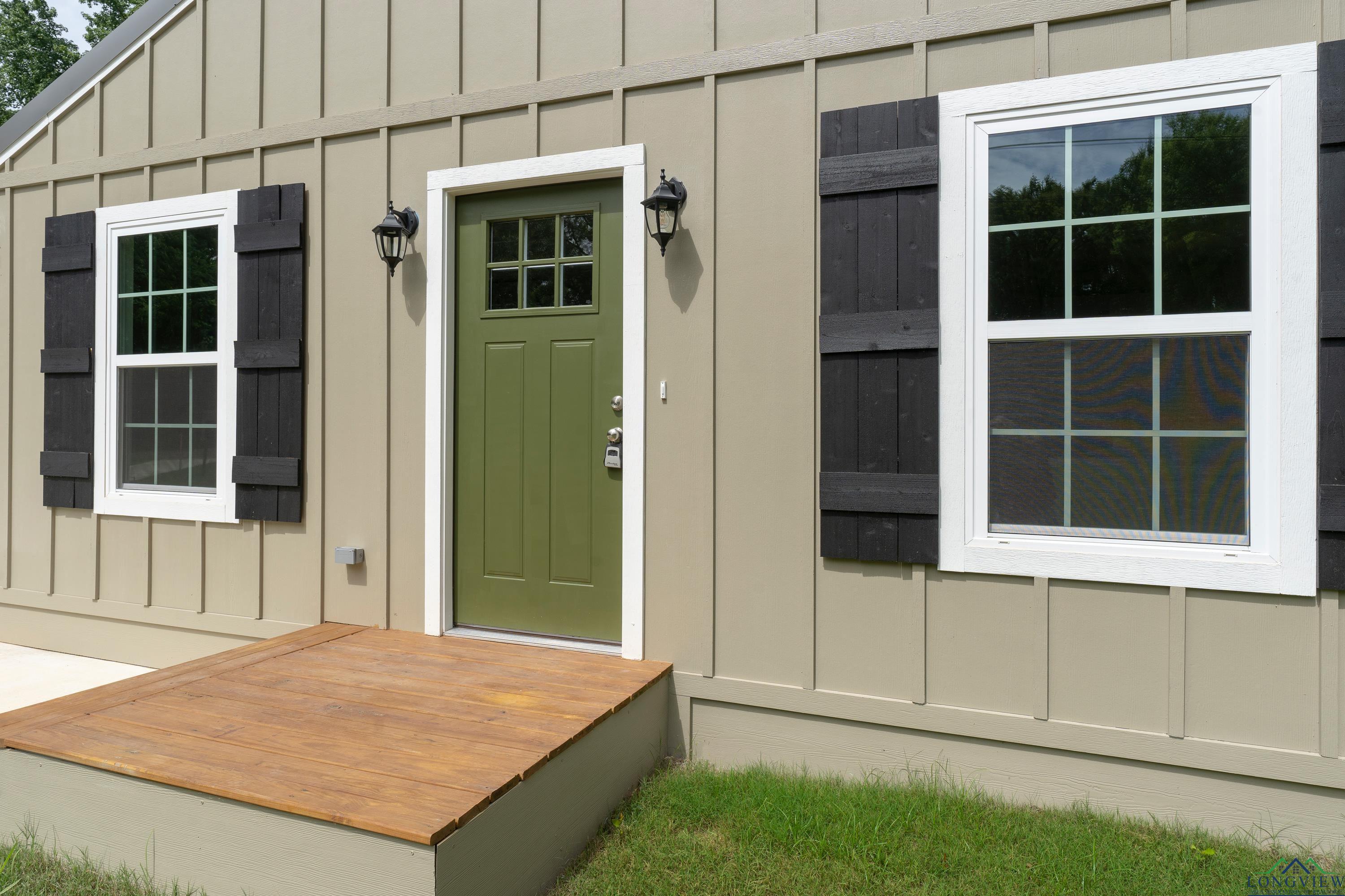 Image 3: View of exterior entry featuring board and batten siding and a deck, Entry