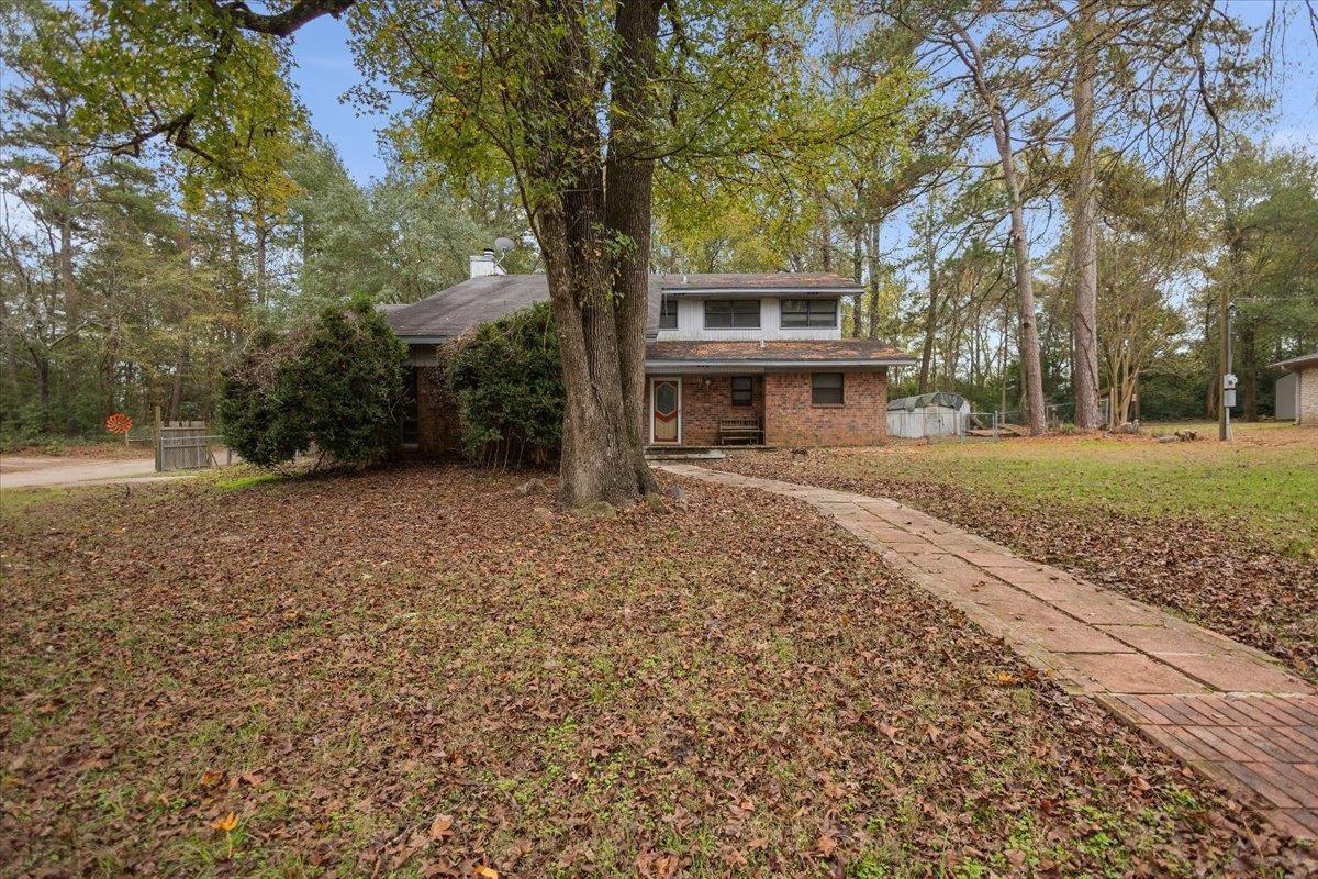 Image 1: View of front facade with a porch and brick siding, Front Of Structure