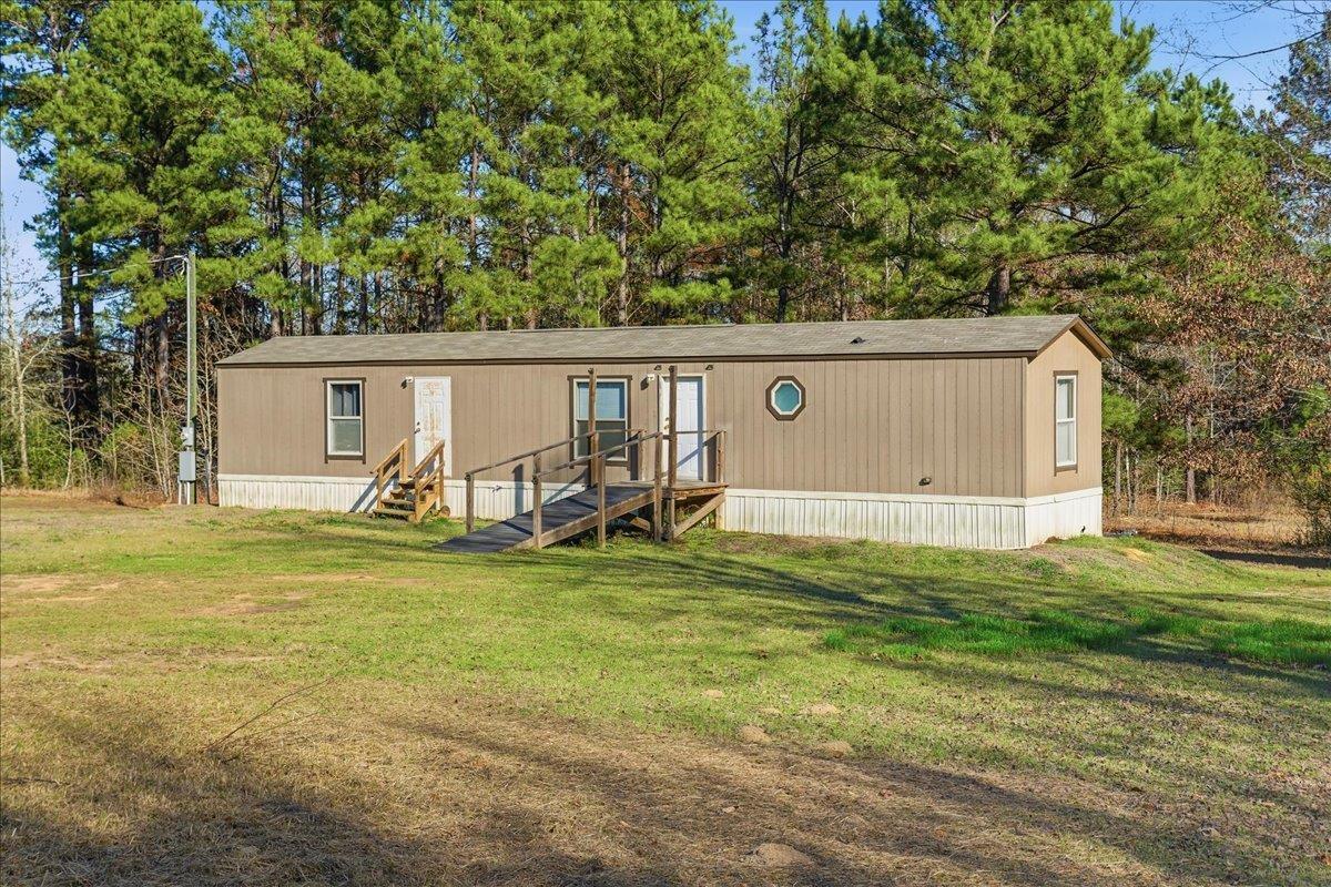 Image 1: Manufactured / mobile home featuring a front lawn, Front Of Structure