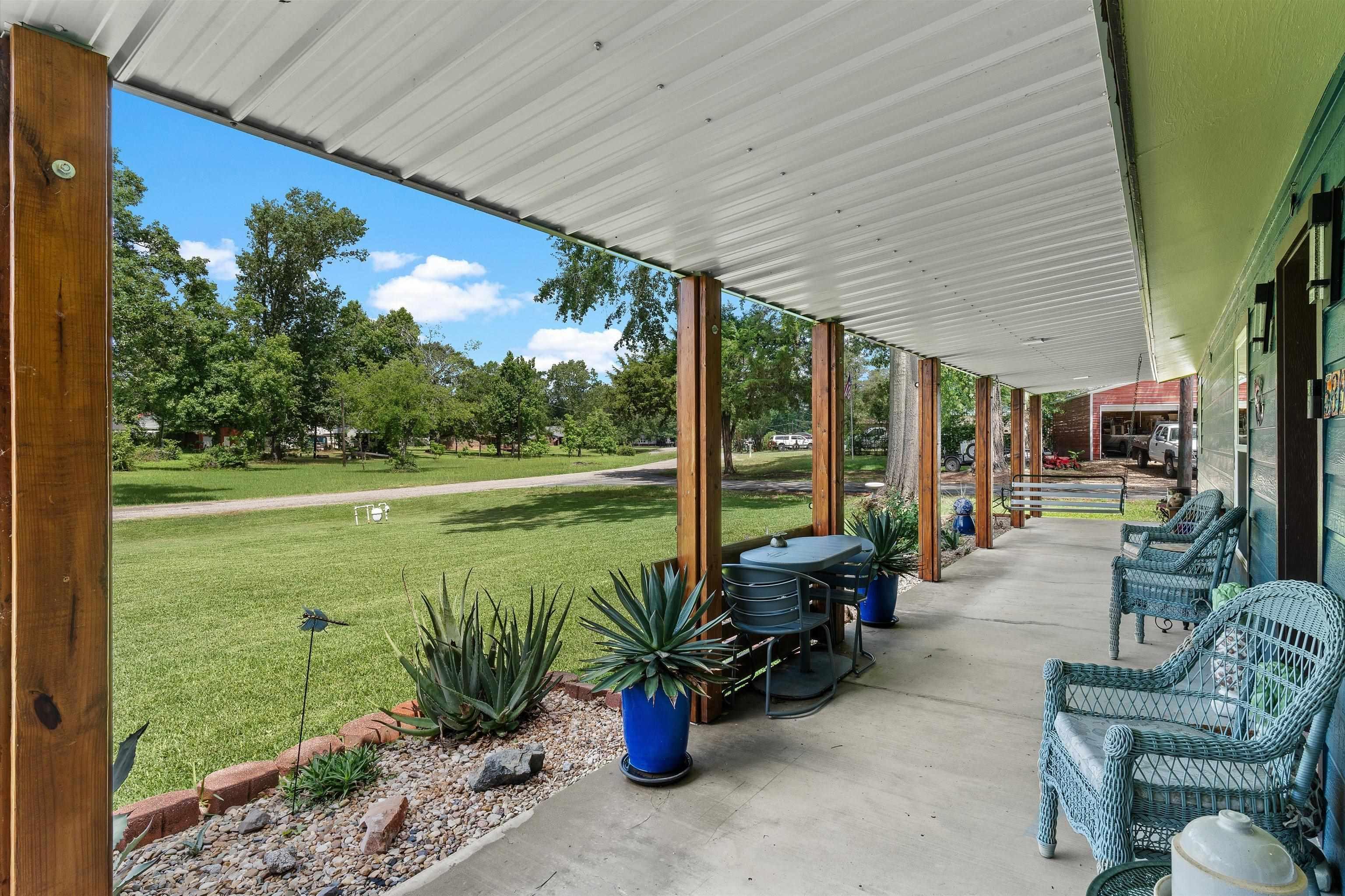 Image 2: Covered porch featuring a yard, Patio
