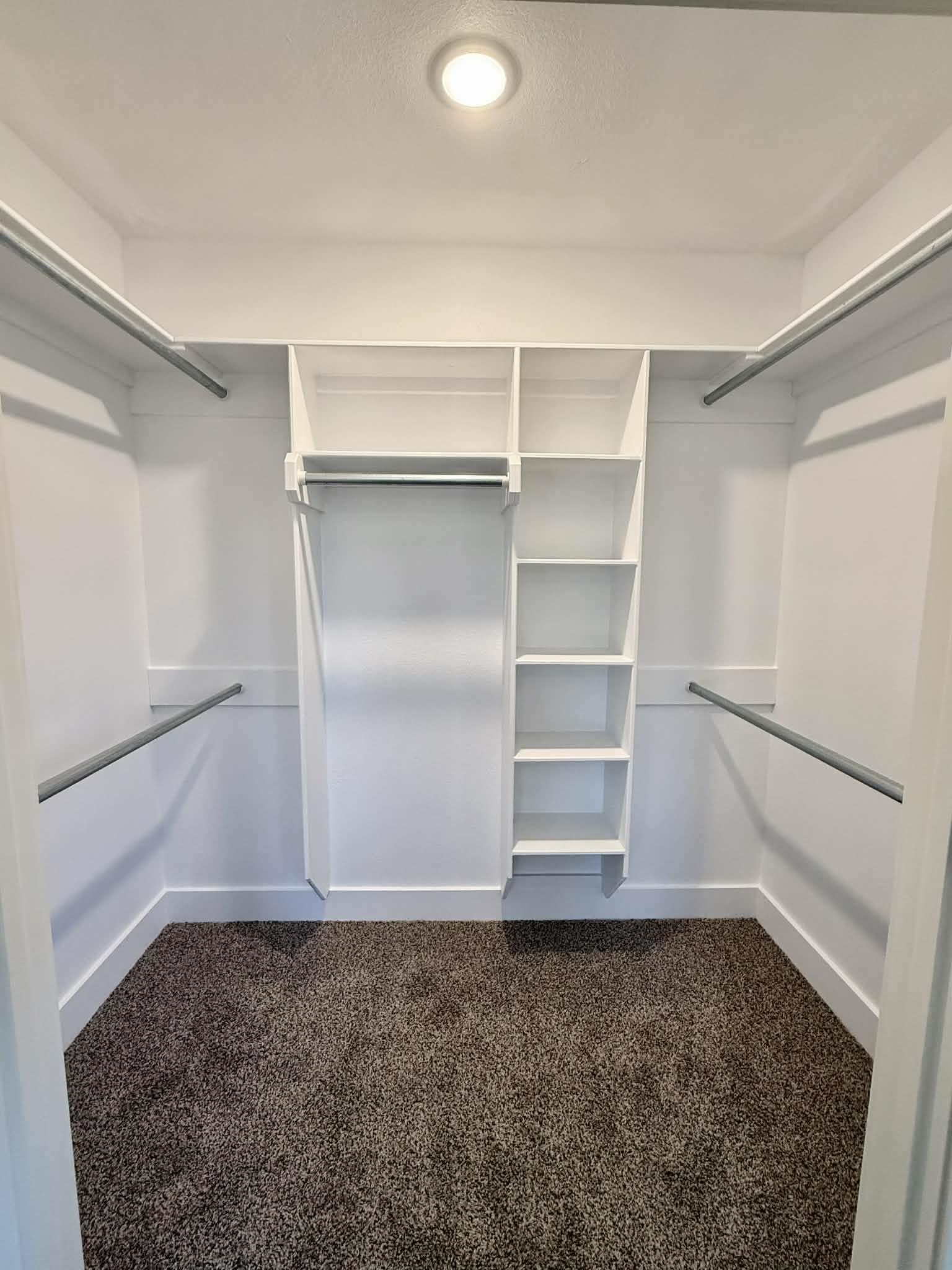 Image 2: Walk in closet with dark carpet, Walk In Closets