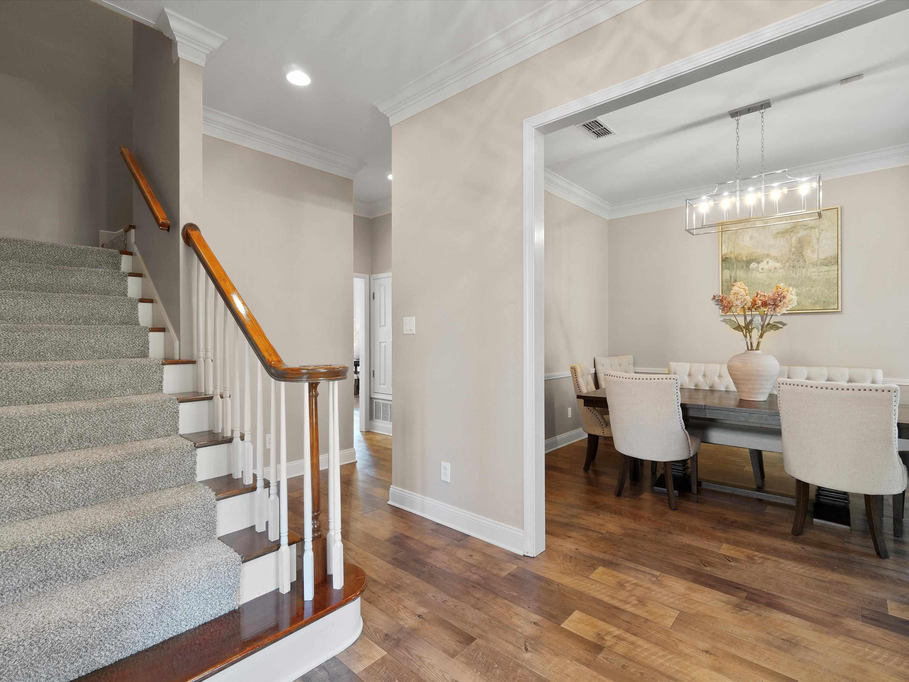 Image 3: Carpeted staircase with wood-finish handrail and balusters, Dining Area