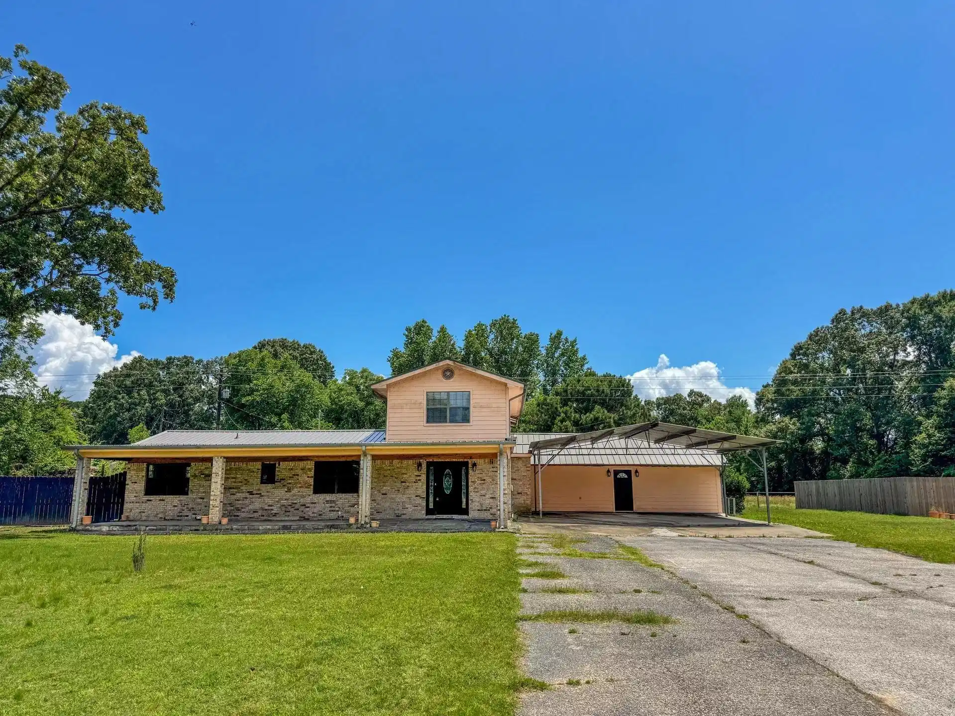 Image 0: Exterior featuring a covered front porch, brick facade, and a metal roof, Front Of Structure