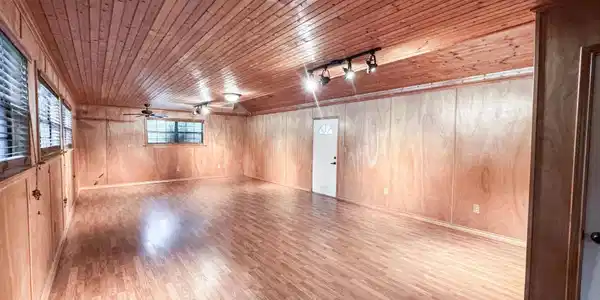 Image 2: Spacious room featuring wood-finish flooring, wood paneling, and a wood-plank ceiling, Other