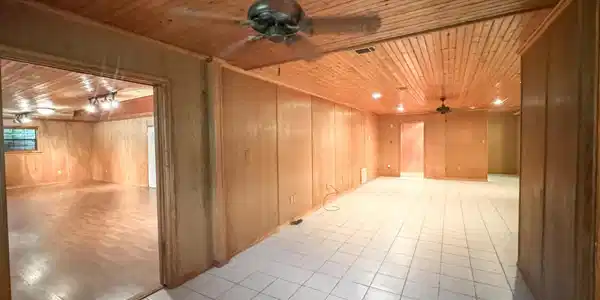 Image 3: Spacious room featuring wood paneling throughout, a plank wood-finish ceiling, and light-toned square tile flooring, Other
