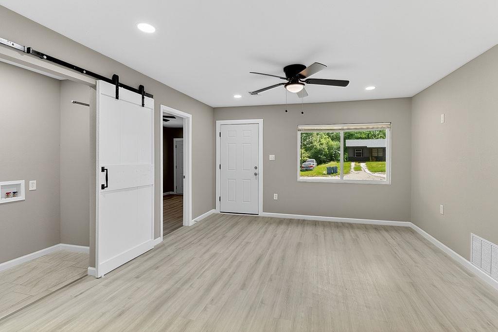 Image 1: Room featuring wood-finish flooring, recessed lighting, and a modern ceiling fan, Living Room