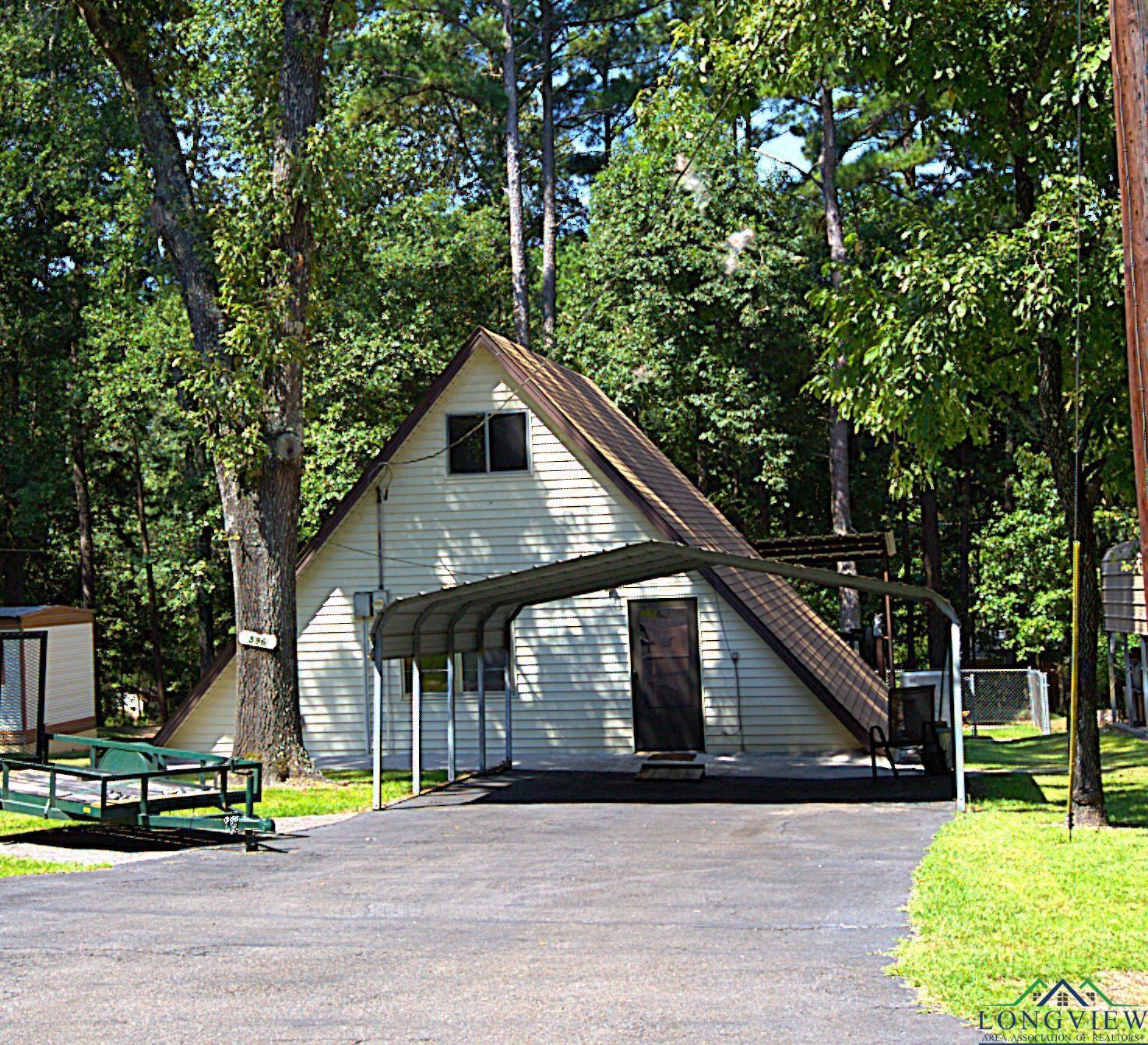 Image 1: Driveway and a detached carport