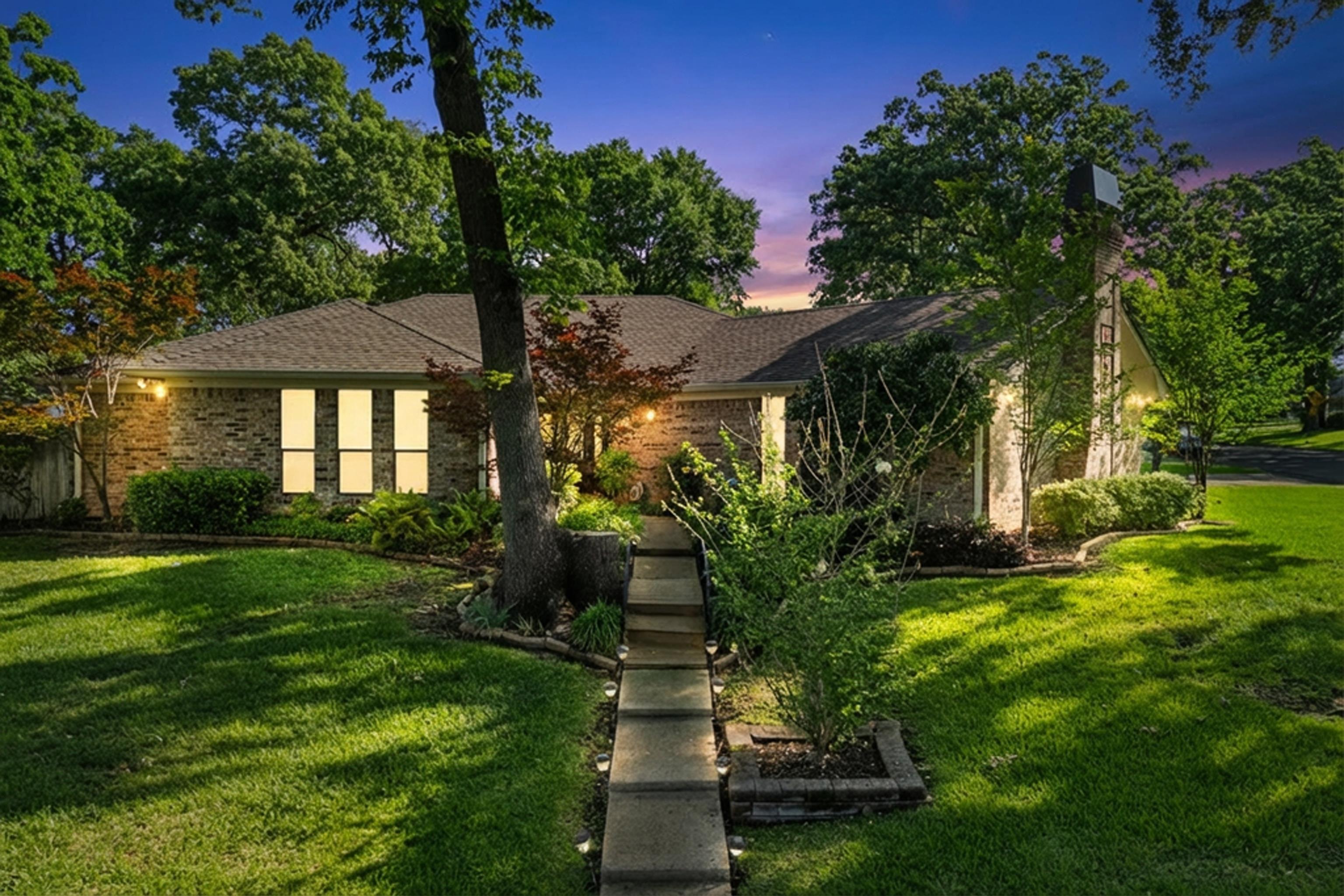 Image 0: View of front of property with a lawn, brick siding, and roof with shingles, Front Of Structure