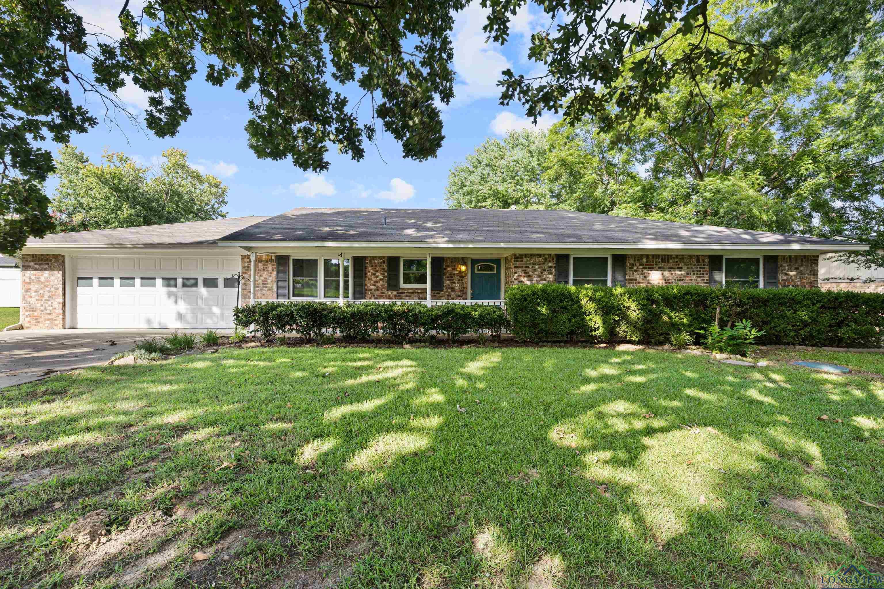Image 0: Ranch-style home featuring concrete driveway, an attached garage, a front yard, and brick siding, Front Of Structure