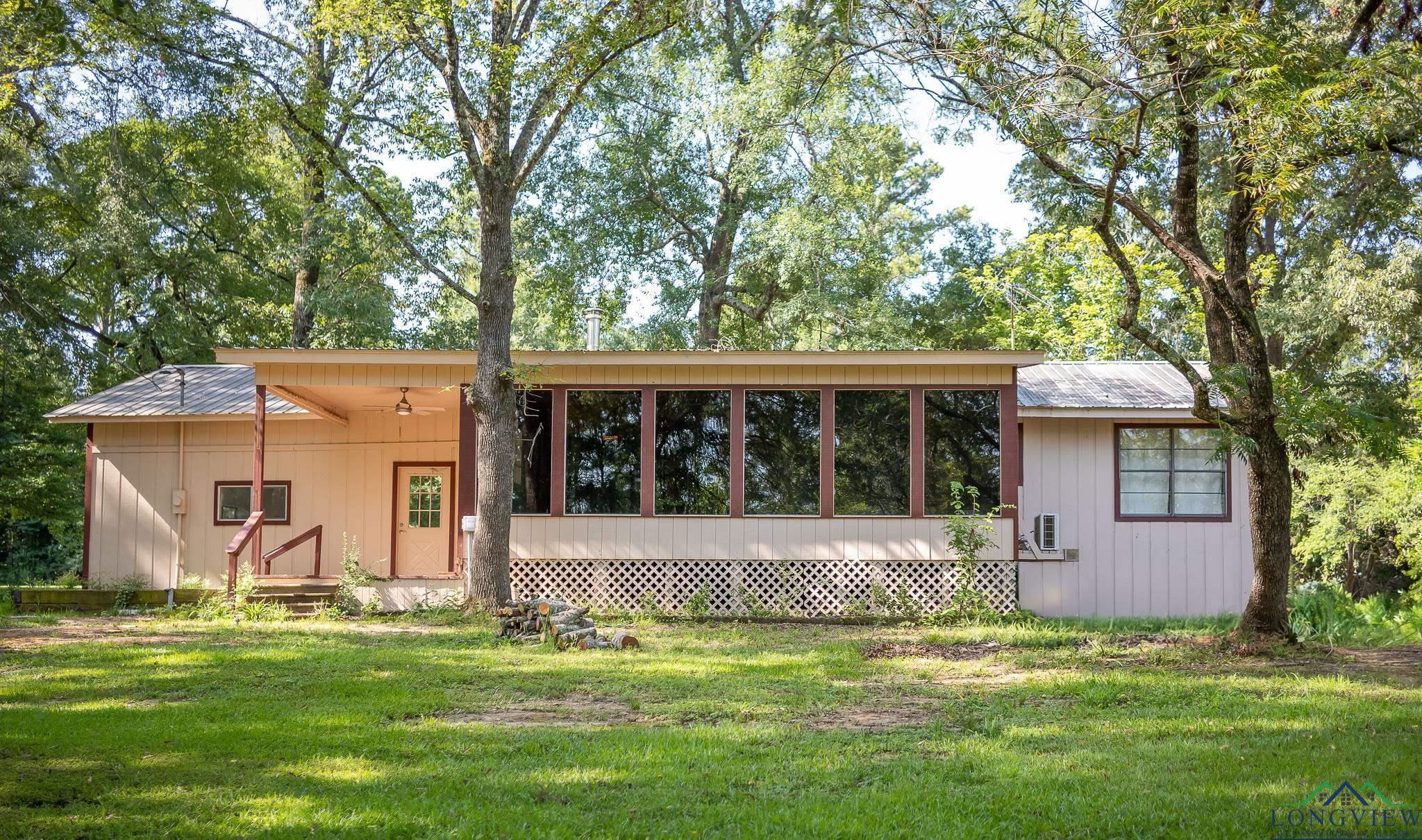 Image 1: Rear view of house with a yard and ceiling fan, Back Of Structure
