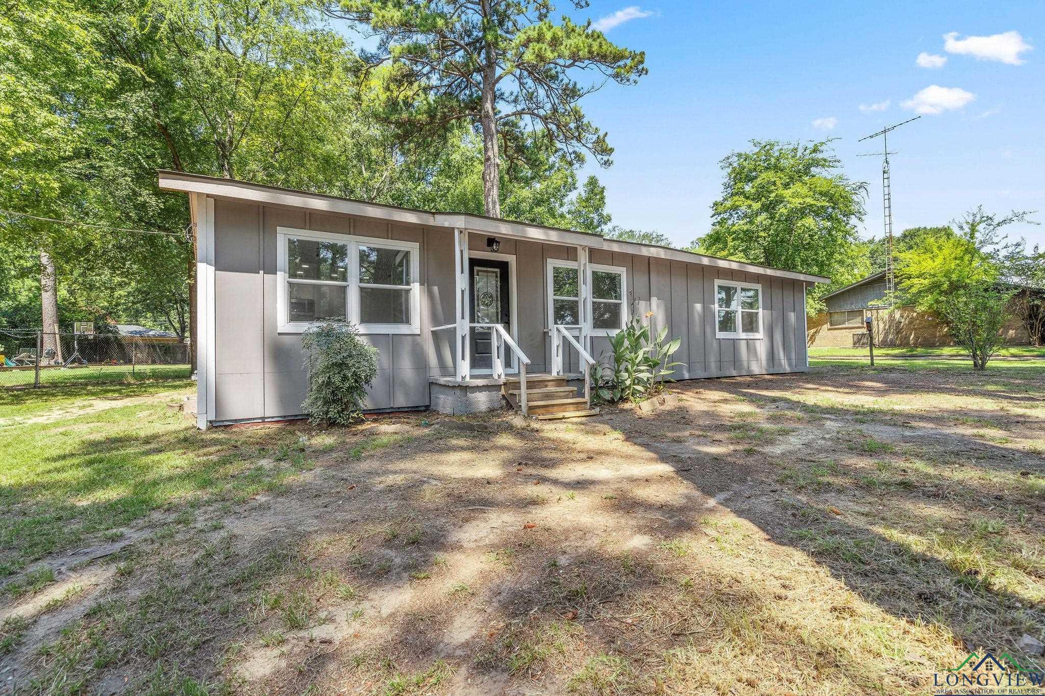 Image 0: View of front of property with board and batten siding, Front Of Structure