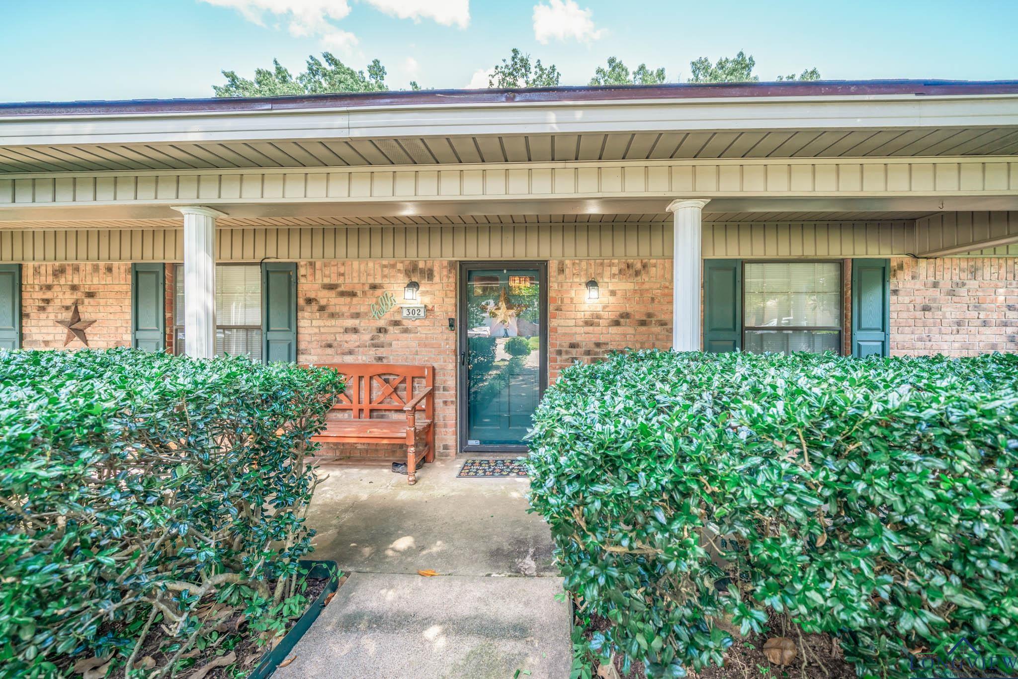 Image 2: View of exterior entry featuring a porch and brick siding, Entry