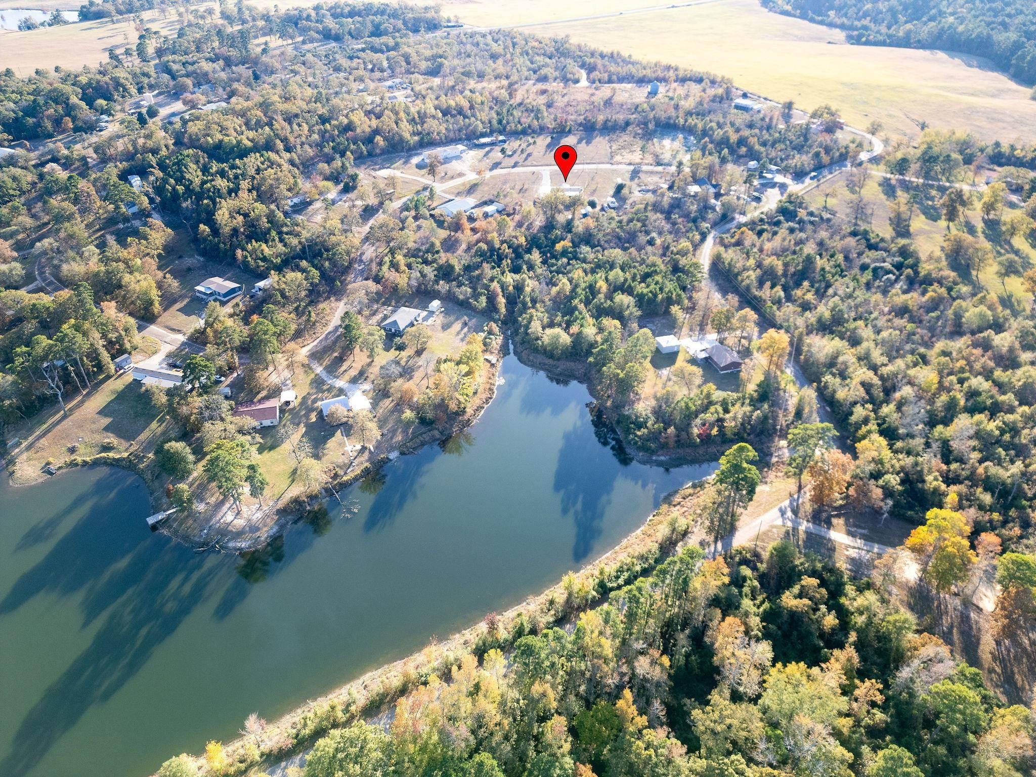 Image 1: Aerial overview of property's location with a large body of water, Aerial View