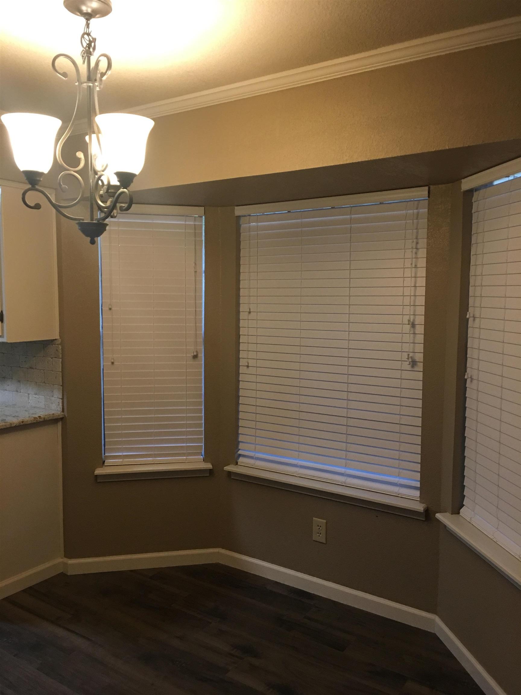 Image 3: Unfurnished dining area with ornamental molding, dark wood-style flooring, and a chandelier, Dining Area