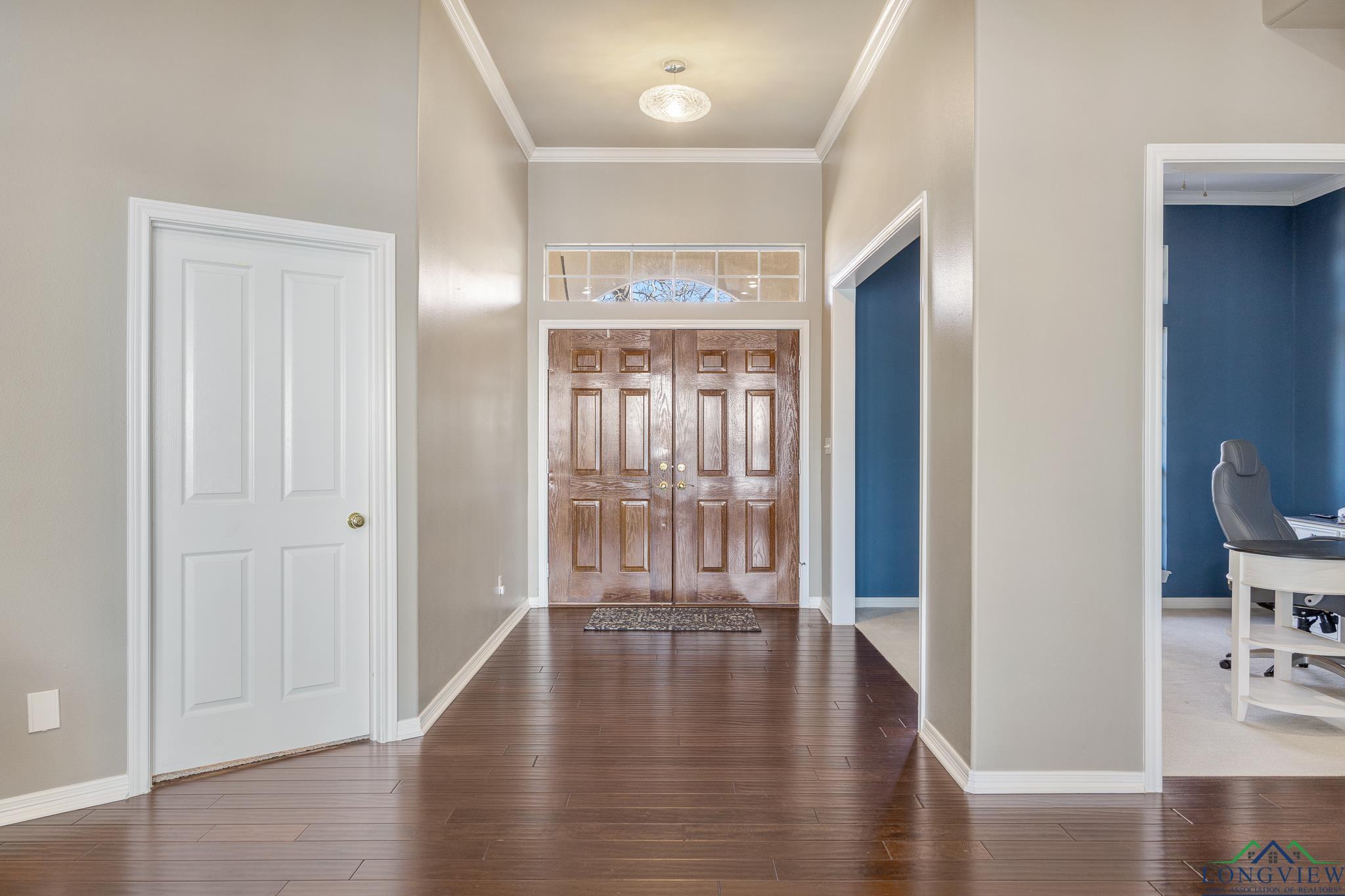 Image 3: Entryway featuring hardwood / wood-style flooring and ornamental molding, Entrance Foyer