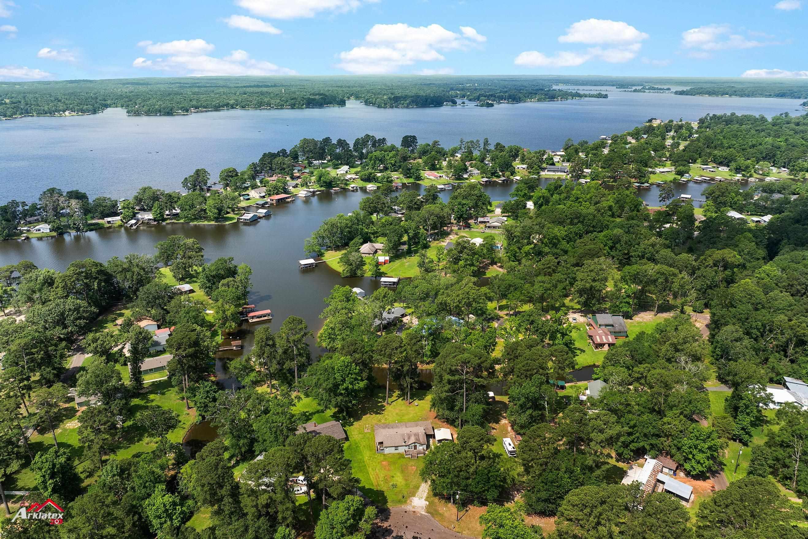 Image 3: Aerial view of property and surrounding area featuring a nearby body of water, Aerial View