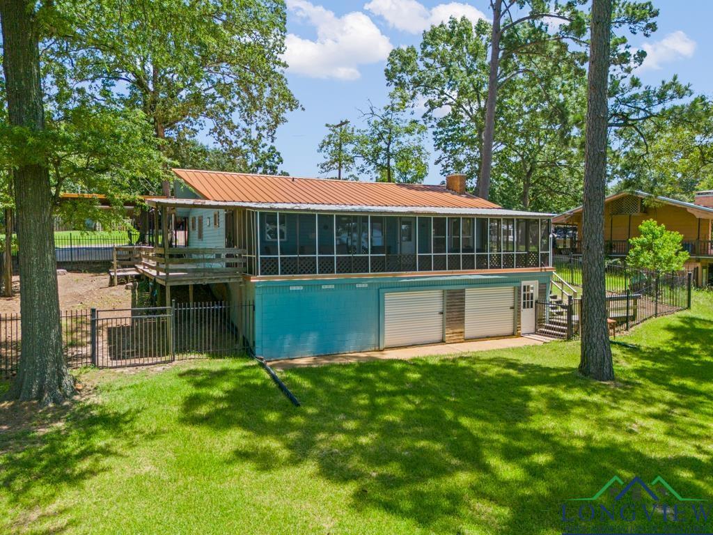 Image 3: View of pool with a sunroom, stairs, and a deck, Pool