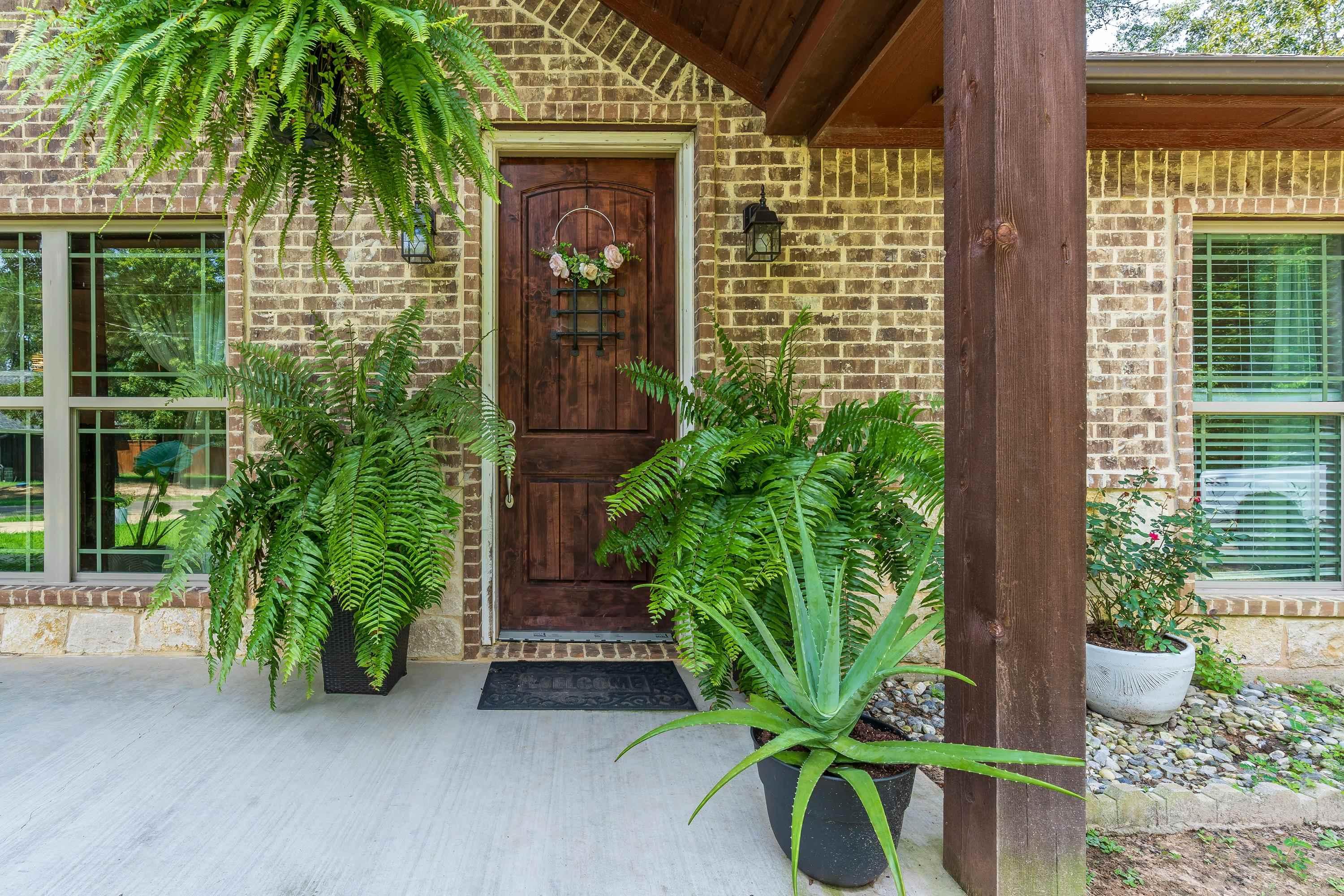 Image 1: Entrance to property featuring brick siding and covered porch, Entry