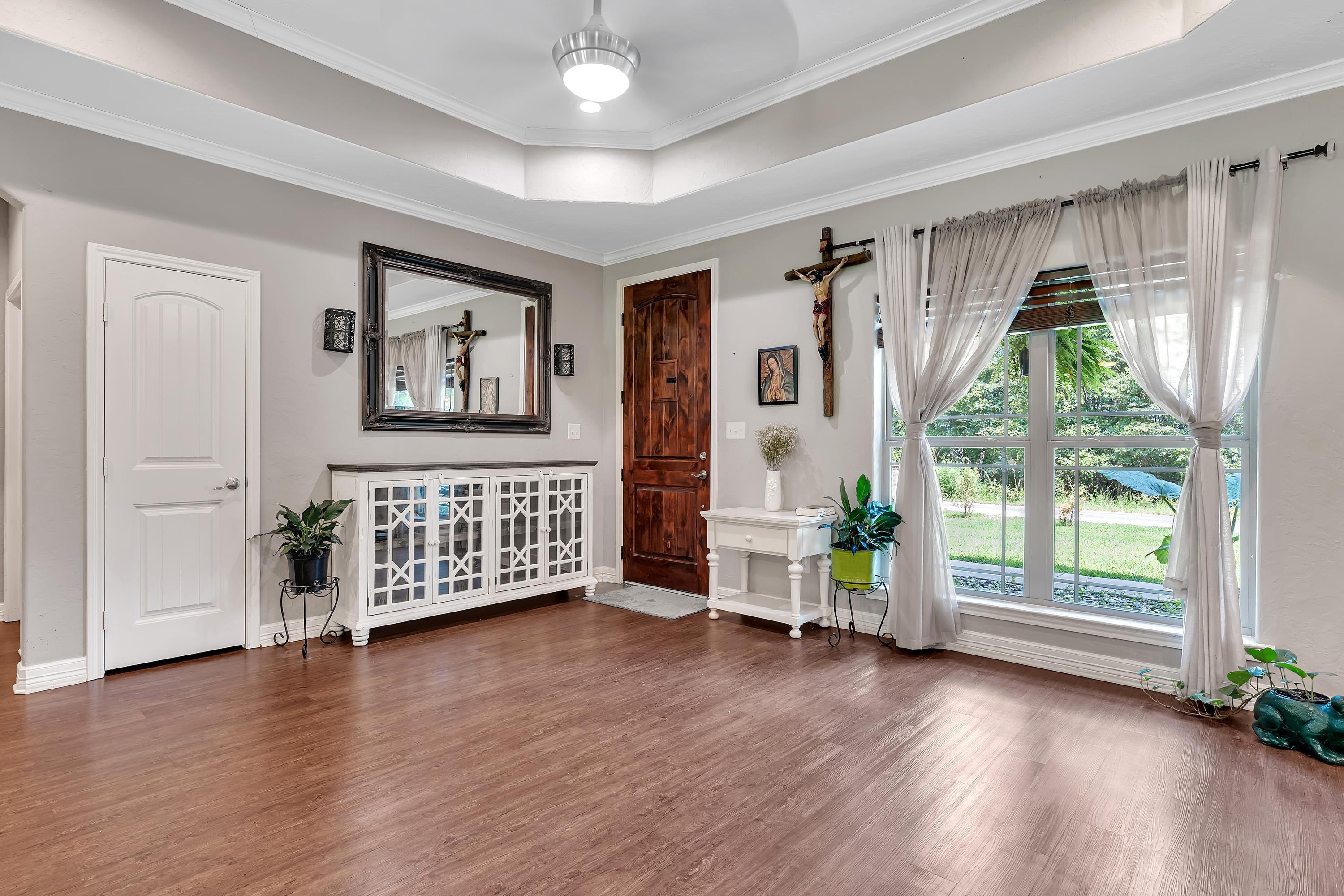 Image 2: Foyer entrance featuring crown molding, a raised ceiling, and wood finished floors, Entrance Foyer