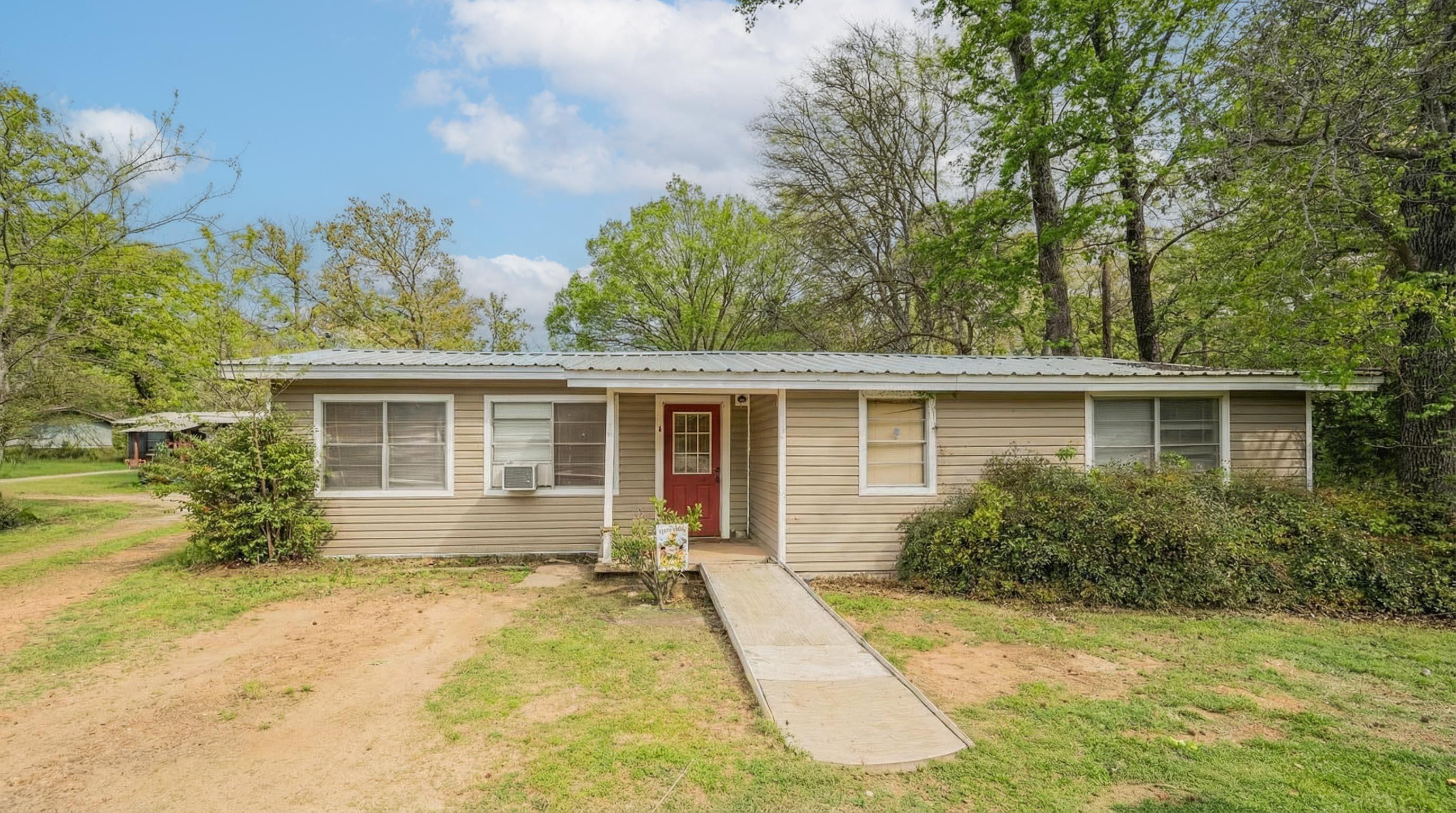 Image 2: View of front of house with a front lawn, Front Of Structure