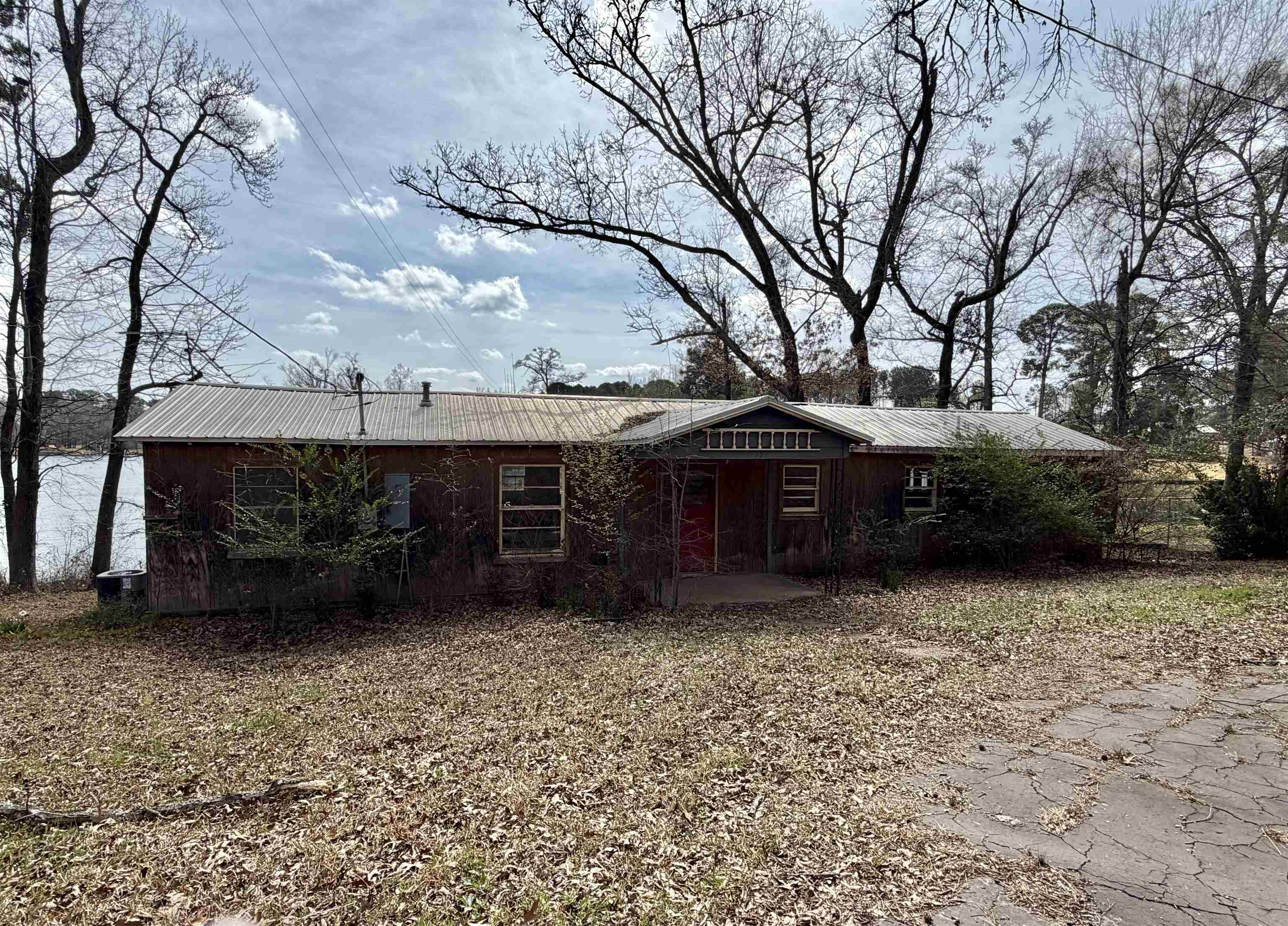 Image 0: Ranch-style home featuring a metal roof and a porch, Front Of Structure