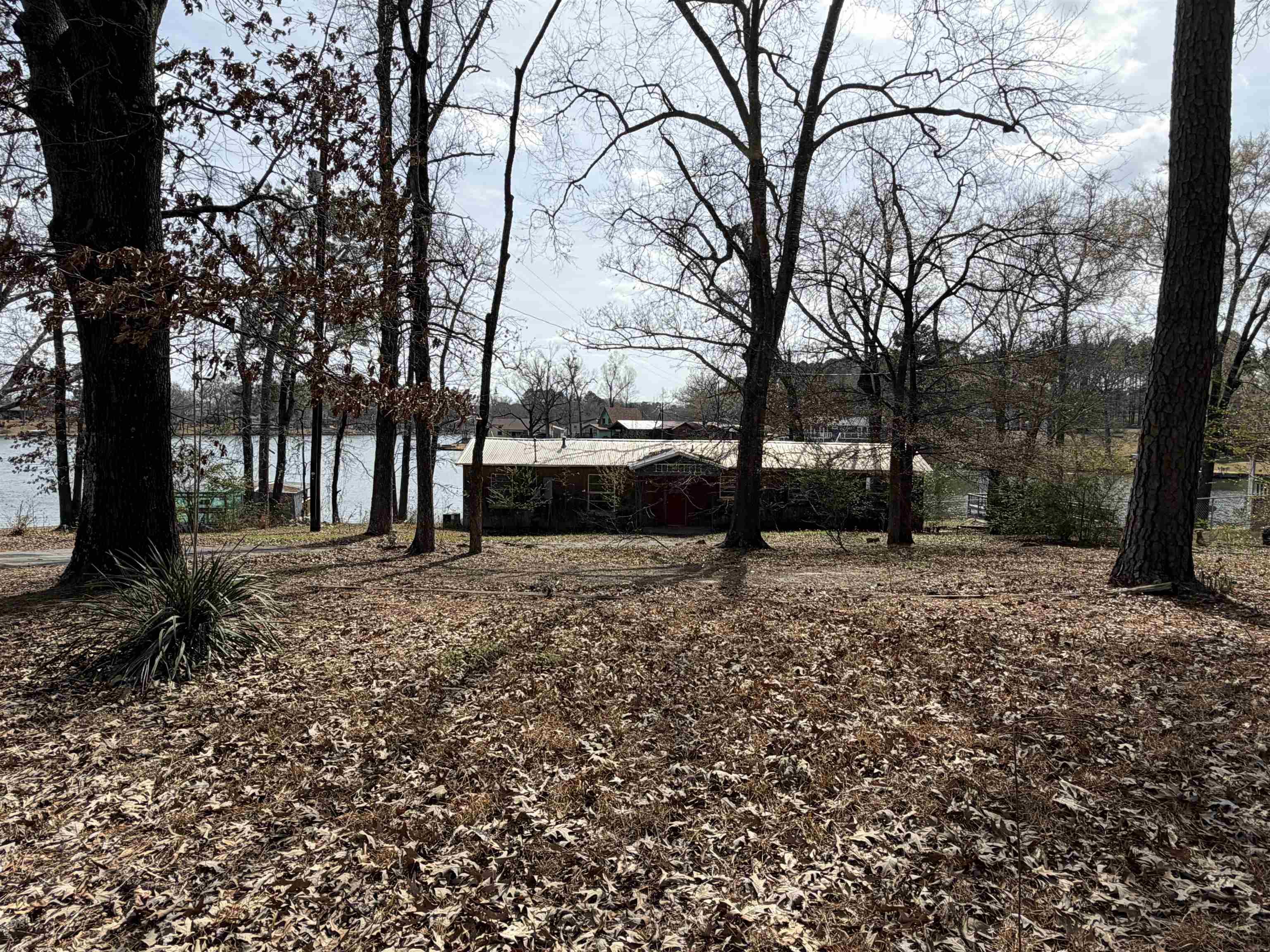 Image 1: View of yard featuring a water view, Yard
