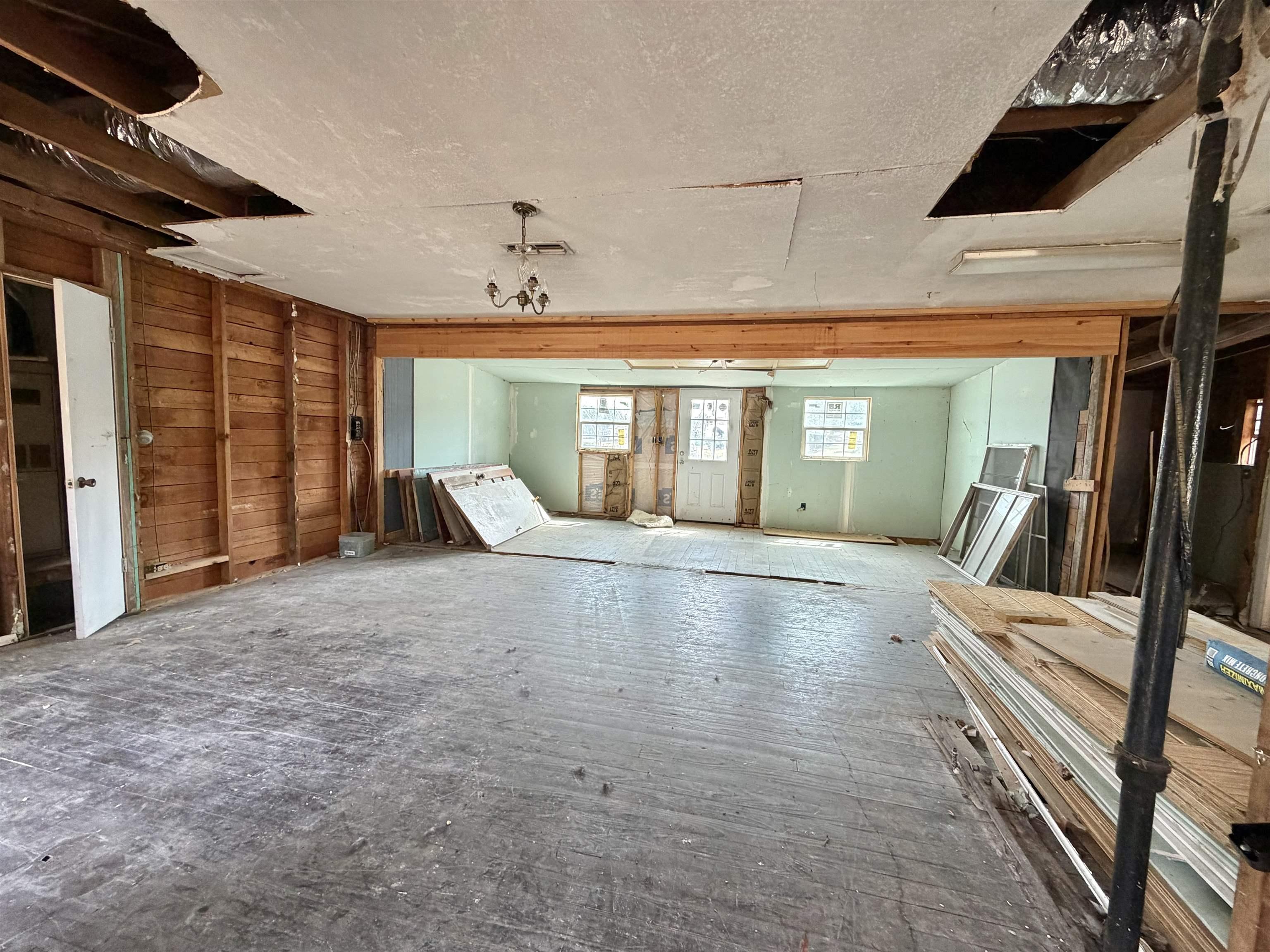Image 2: Misc room with hardwood / wood-style floors and a textured ceiling, Other