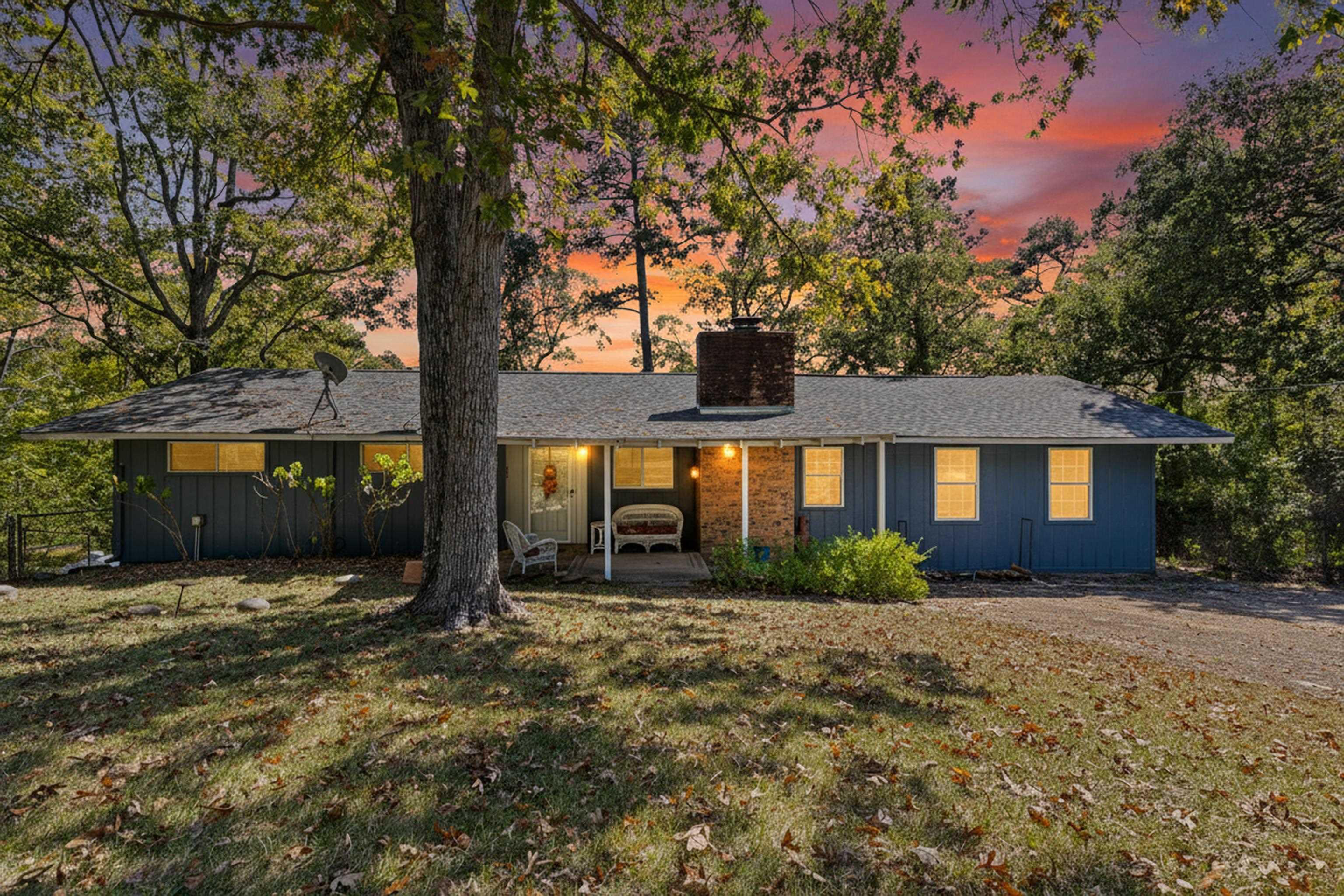 Image 2: Ranch-style home featuring a chimney, a patio, a yard, and roof with shingles, Front Of Structure