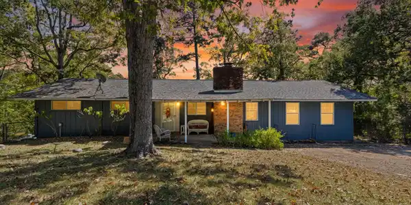 Image 2: Ranch-style home featuring a chimney, a patio, a yard, and roof with shingles, Front Of Structure