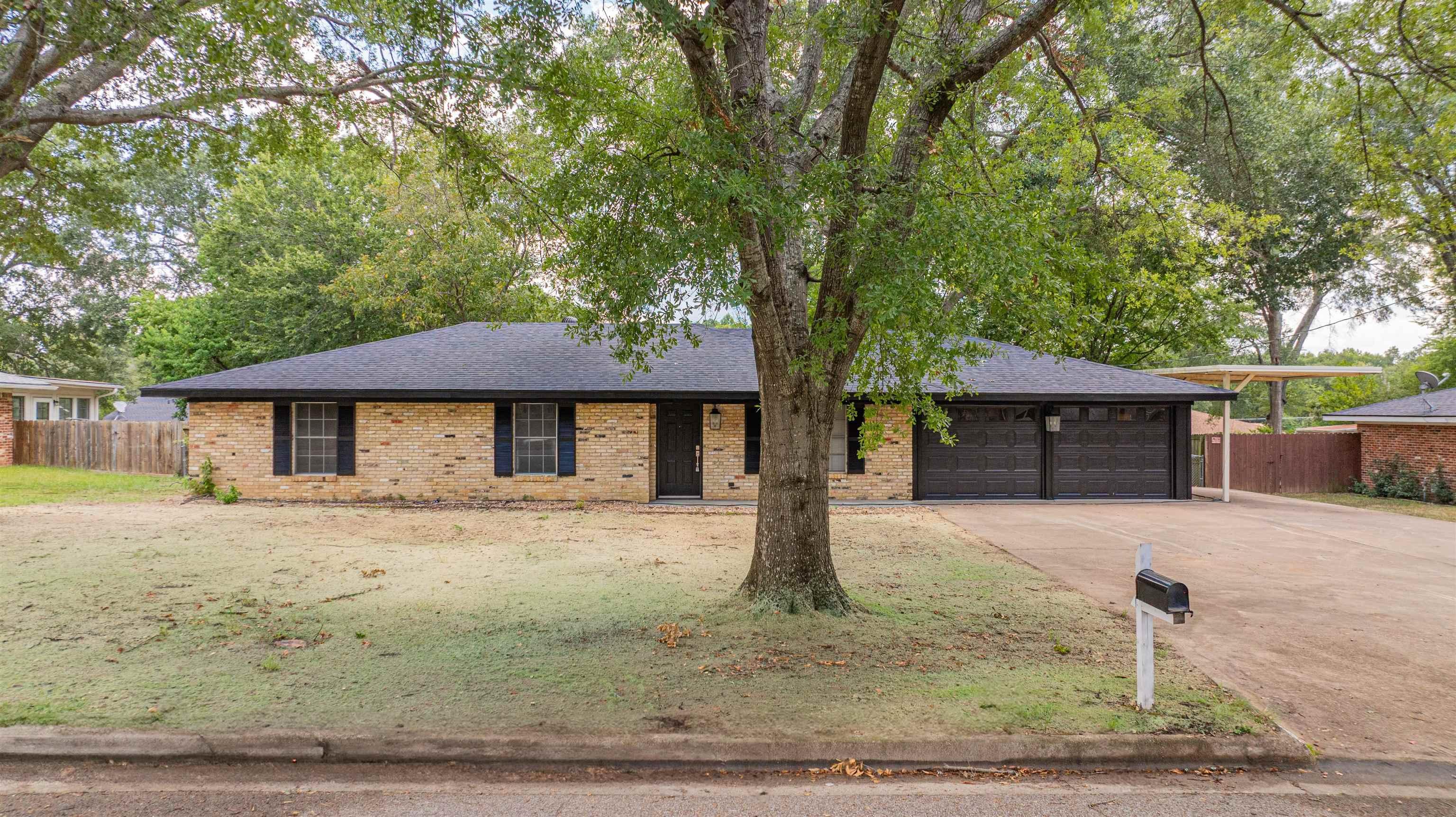 Image 1: Ranch-style house with brick siding, a garage, a shingled roof, and concrete driveway, Front Of Structure