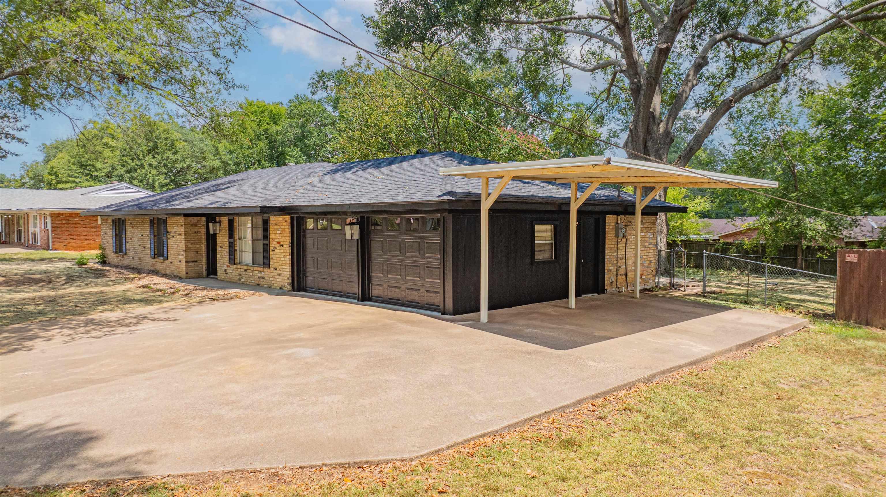 Image 2: Garage featuring driveway and a carport, Garage