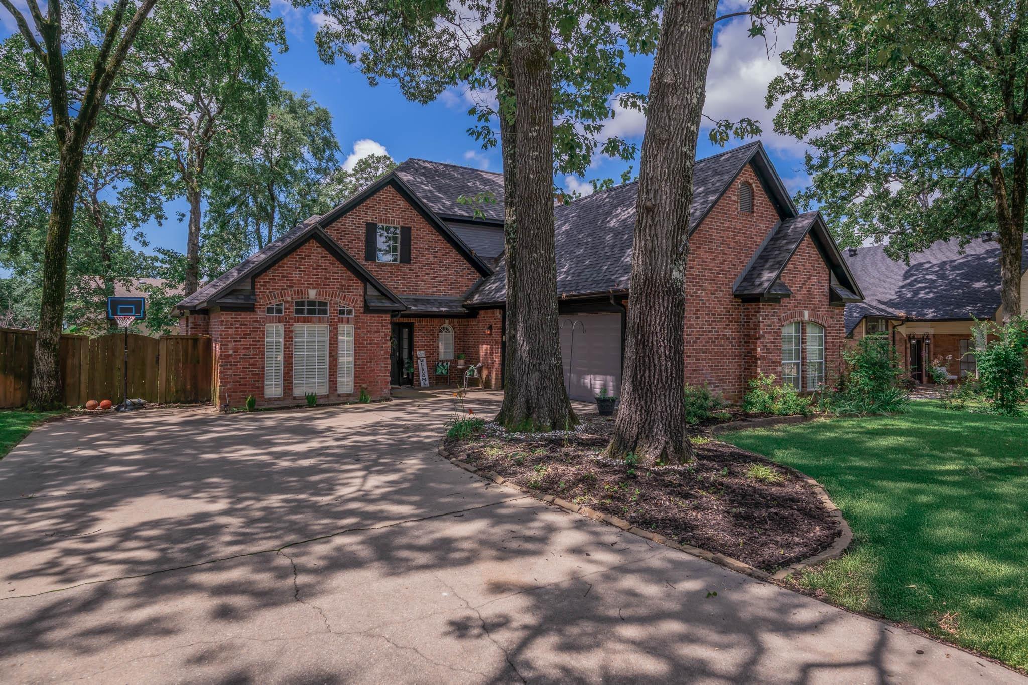 Image 2: Traditional-style home with brick siding and driveway, Front Of Structure
