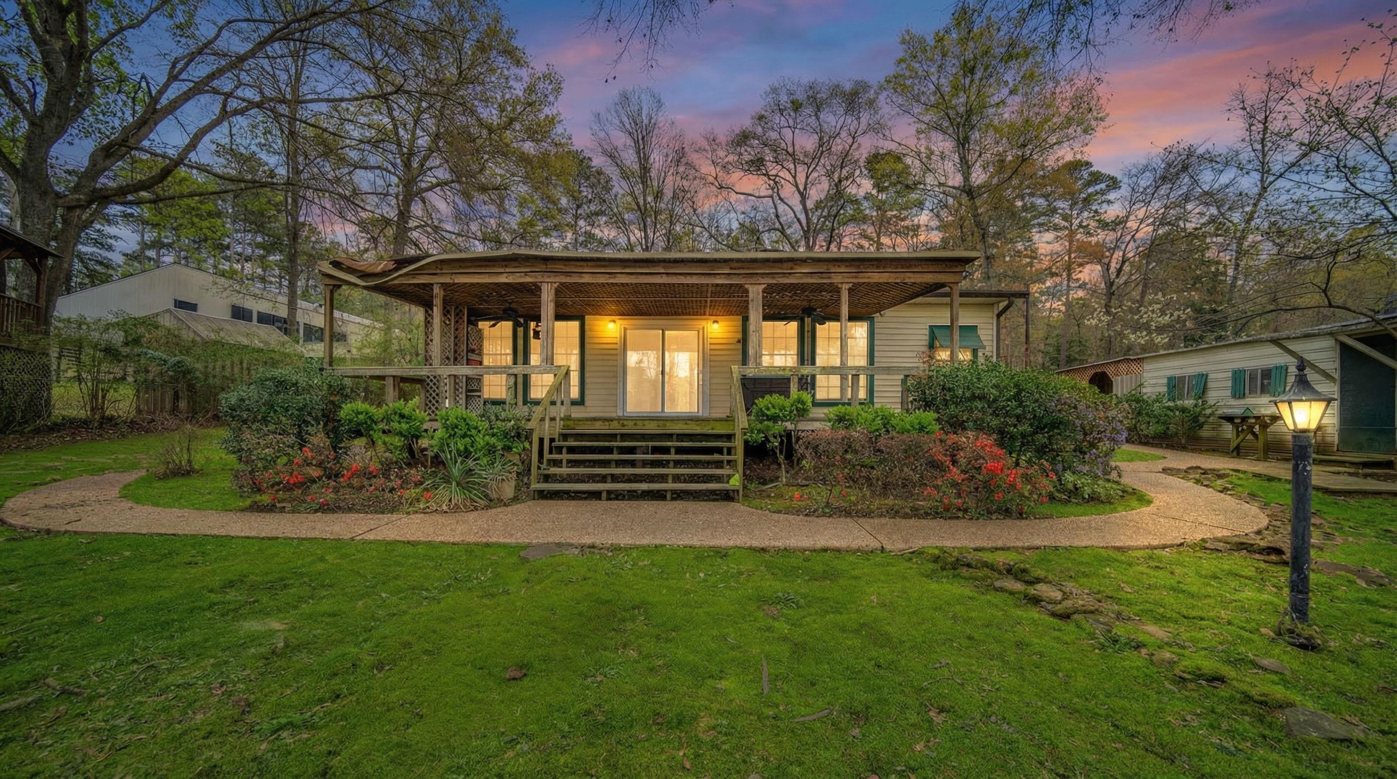 Image 1: Rear view of property with a porch, a yard, and french doors, Back Of Structure