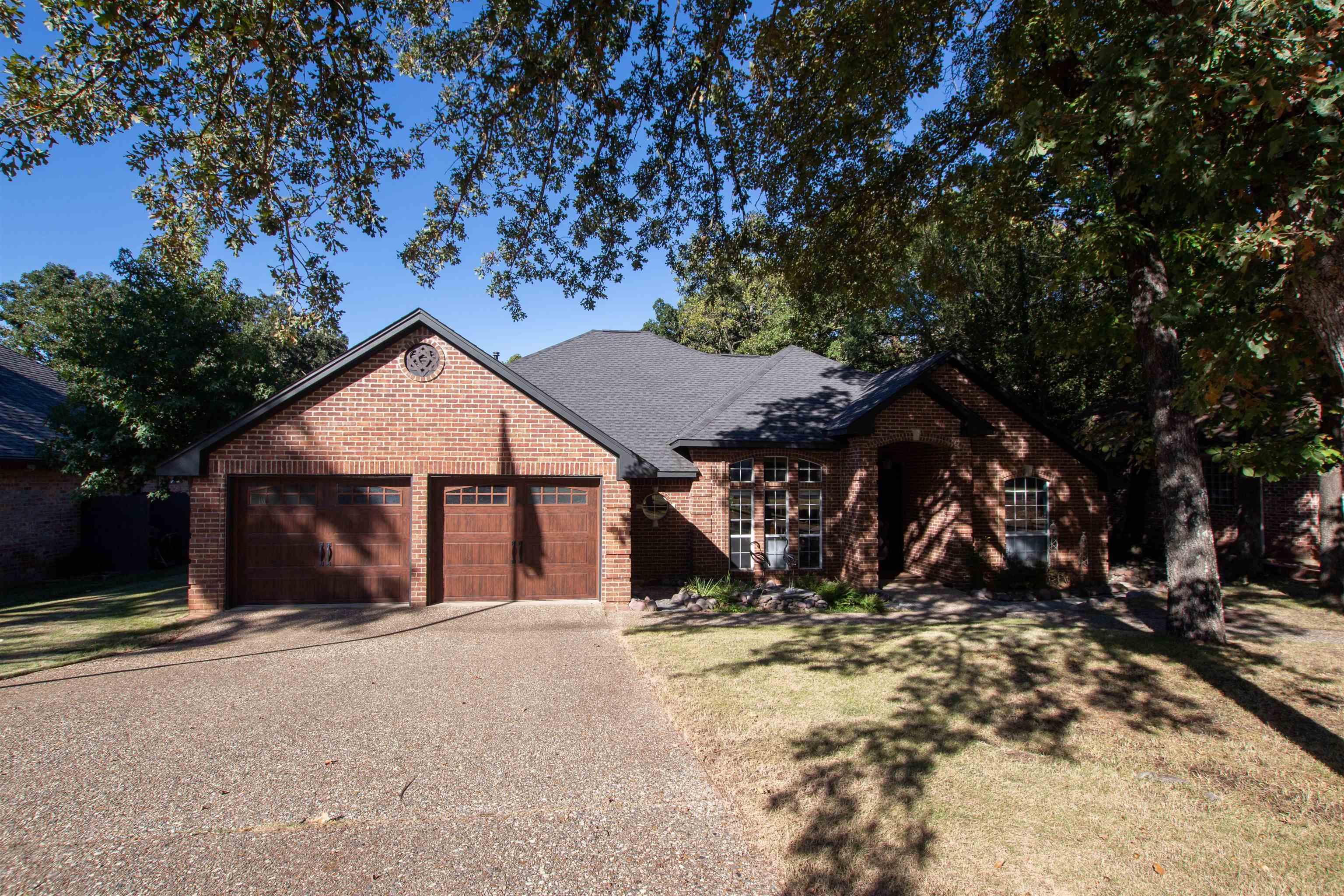 Image 0: View of front facade with brick siding, driveway, a front yard, an attached garage, and roof with shingles, Front Of Structure